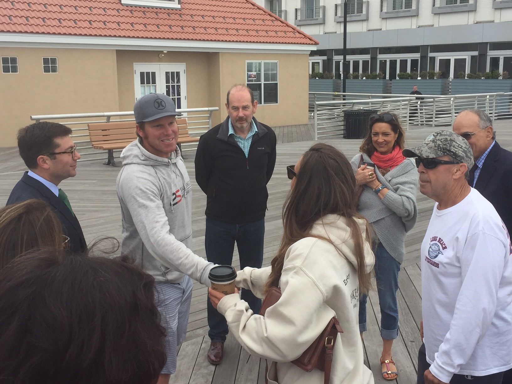 Cliff Skudin greeted Jenny Francis and the other United Kingdom residents on the boardwalk and talked about the surfing culture in Long Beach, including Skudin Surf’s camps and lessons.