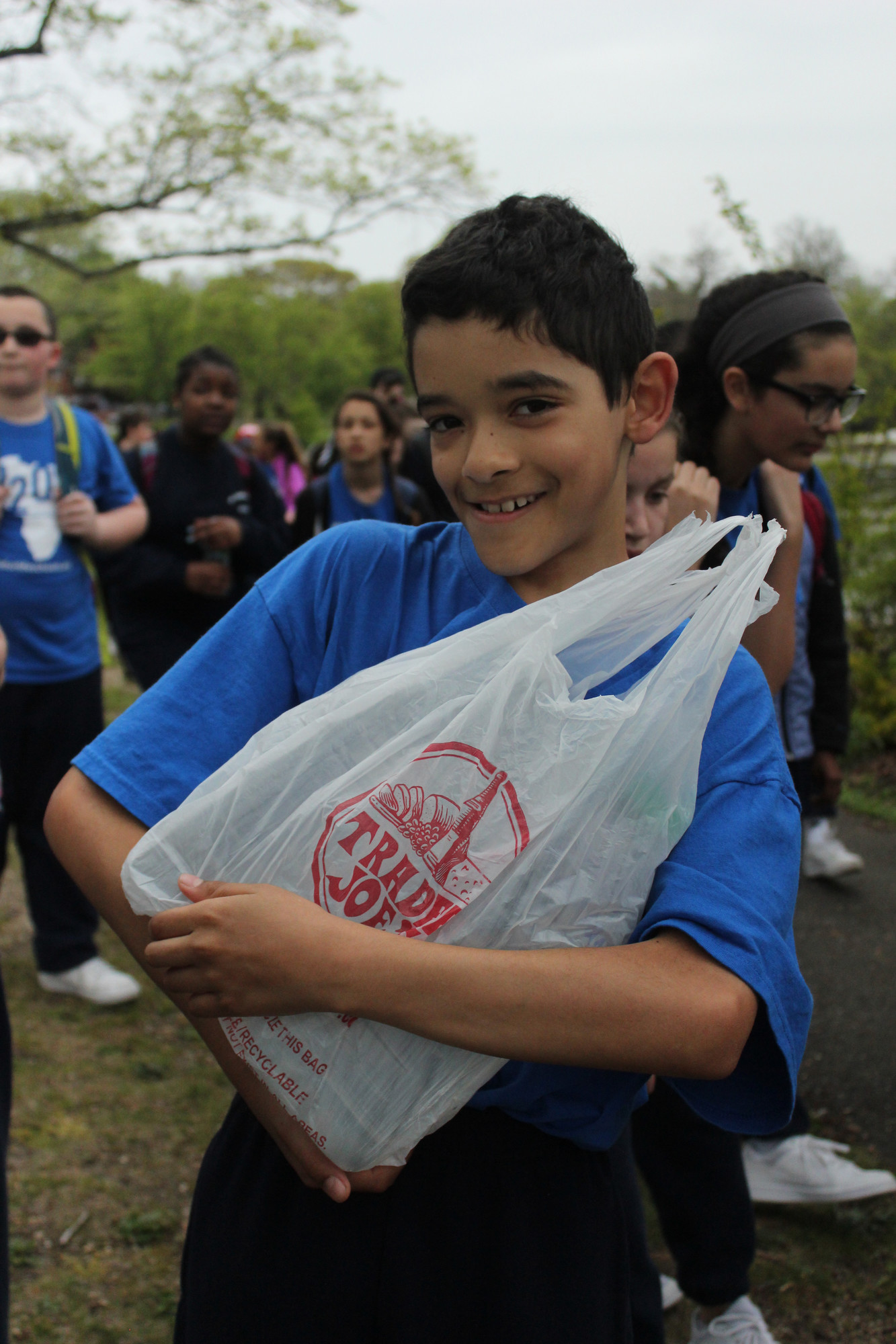 Sixth grader Carlos Santana shows the gallon and a half of water he carried for three miles on Friday.