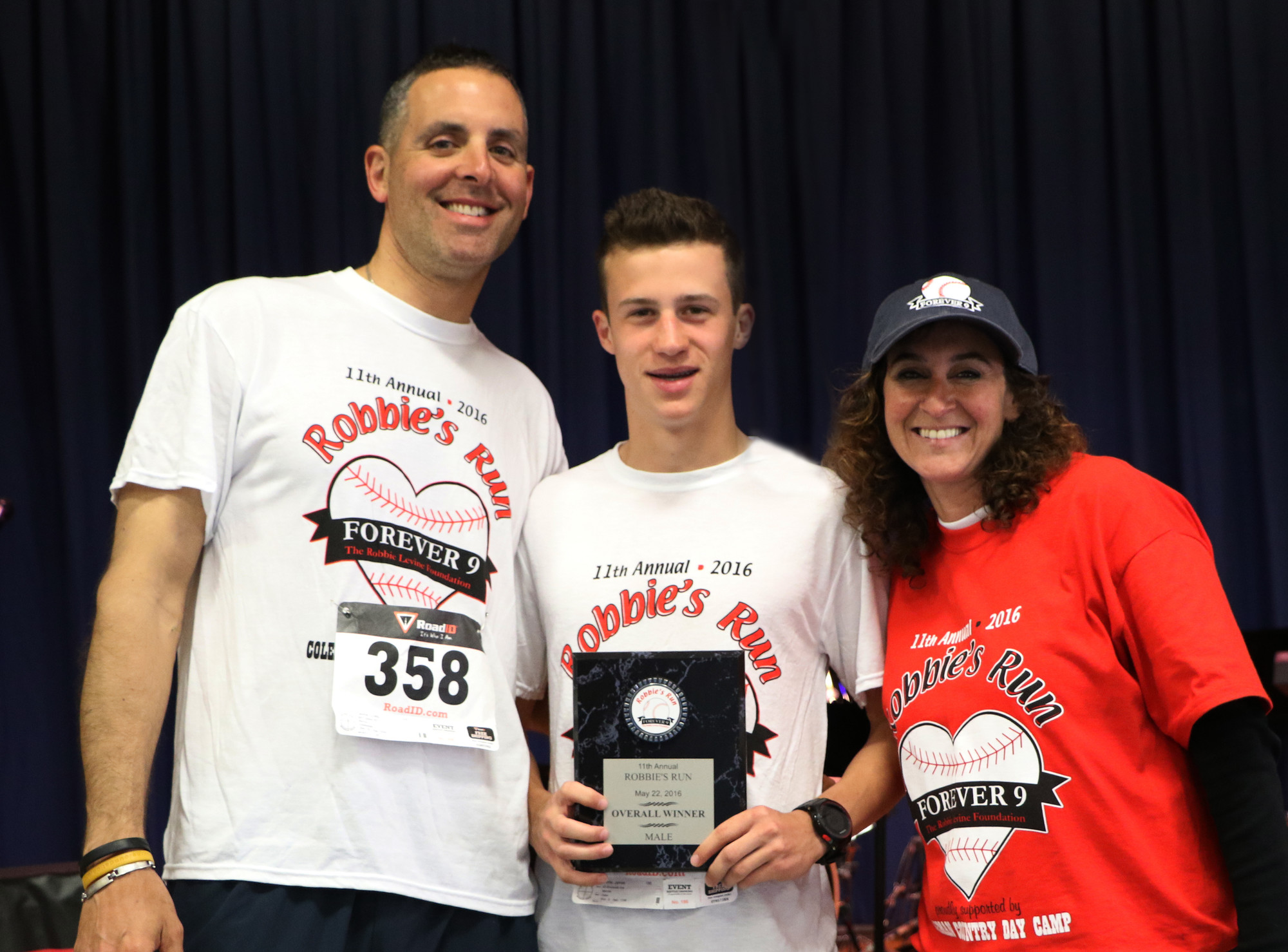 Forever 9 Foundation founders Craig Levine, and his wife, Jill, presented overall winner James Forte with his first-place plaque.