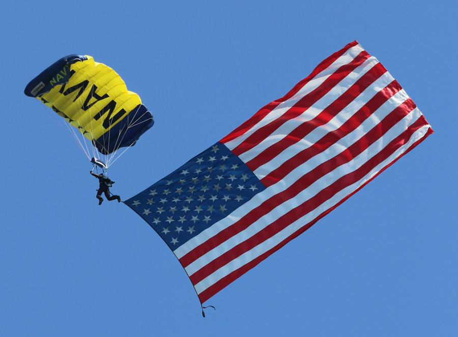 Members of the U.S. Navy Parachute Team, the Leap Frogs, left, performed an aerial demonstration.