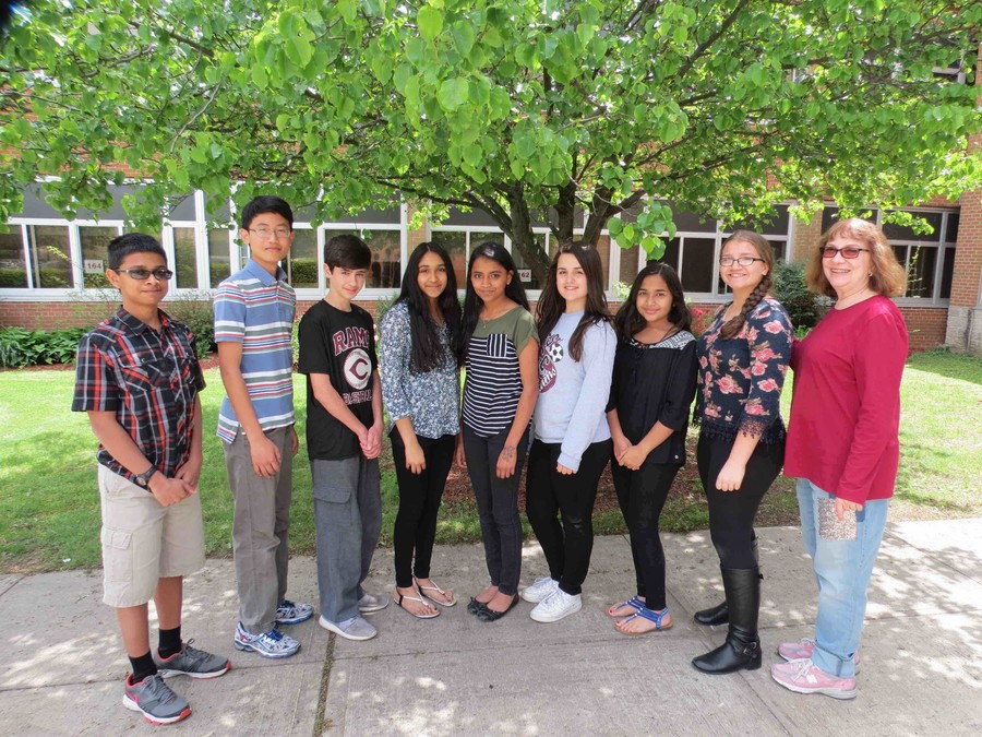 Eighth-graders Ankit Sayed, left, June Yeup Seong, Mark McMahon, Deeti Patel, Sherin Davis, Ana Pinto, Fardeena Yousuf and Arianna Fracchioni qualified to compete in the state competition; Carol Simowitz, a science teacher at W.T. Clarke Middle School, far right, congratulated them for their achievement.