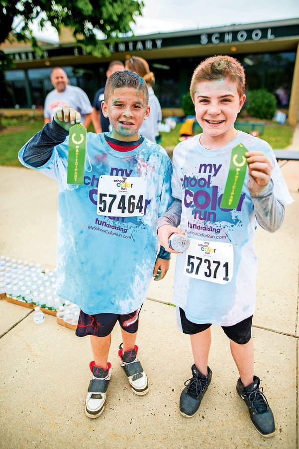 Seaford Harbor Students Dylan Rylander, left, and Kevin Cantlay received ribbons after crossing the finish line at the Color Run.