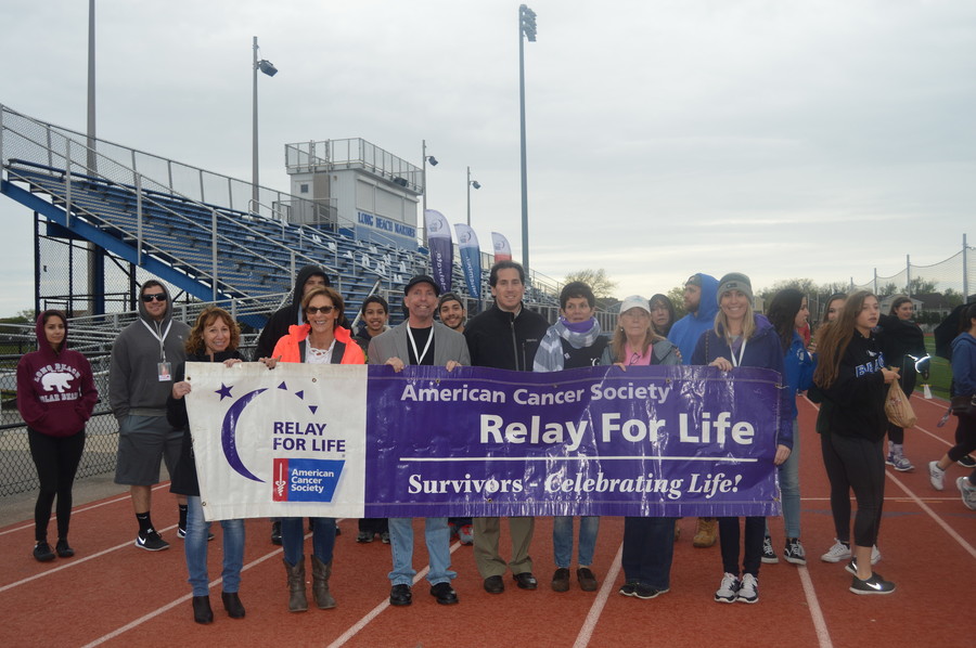 Kara Gumiela, right, whose grandmother, Marie Pichichero, died of uterine cancer in March, along with State Sen. Todd Kaminsky, center, stood with other Relay For Life participants at the Long Beach Middle School track on May 21.