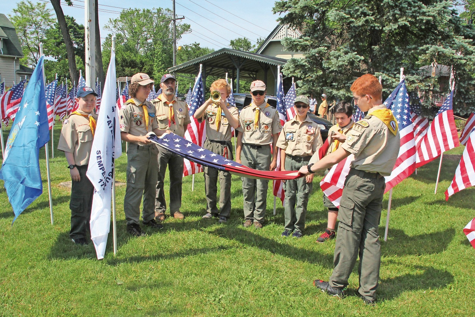 Troop 656 Boy Scouts, from left, John Metress, Matt Seaman, Luke Benedetto, James Seaman and Peter Rowan prepared the American Flag as the second annual Field of Honor was dedicated at the Wantagh Museum on May 29.