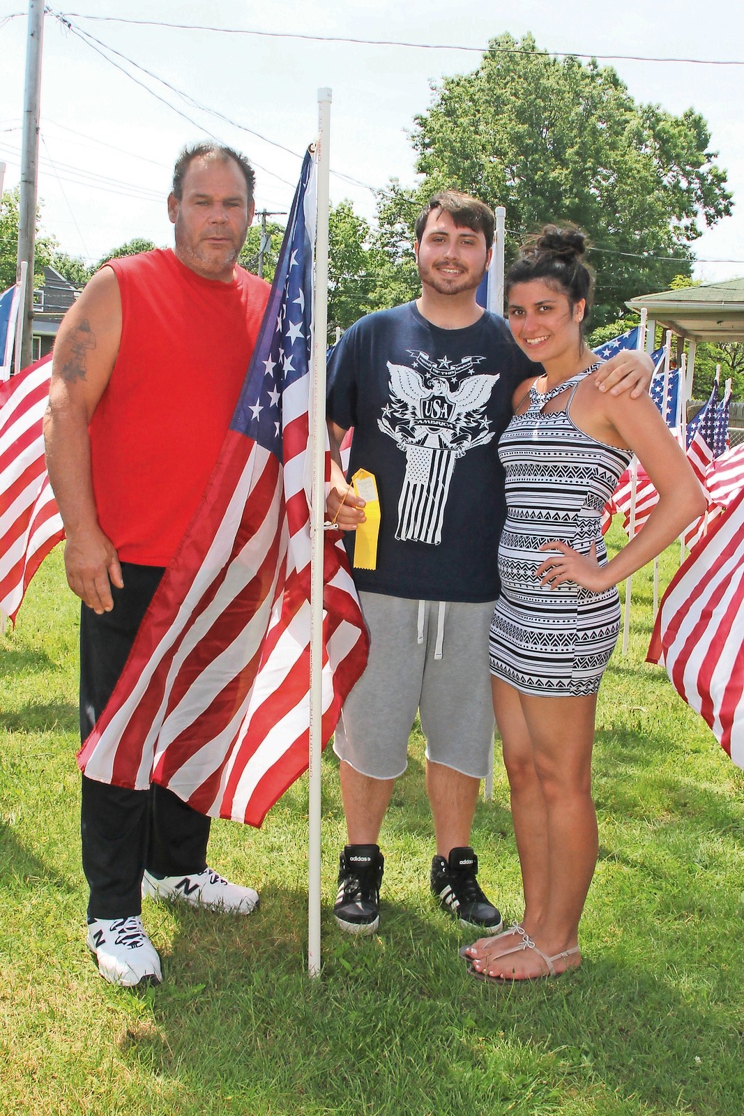 The Macchia Family, from left, Keith, Gianna and Salvatore, at the American Flag to honor World War II Navy veteran Salvatore Macchia.