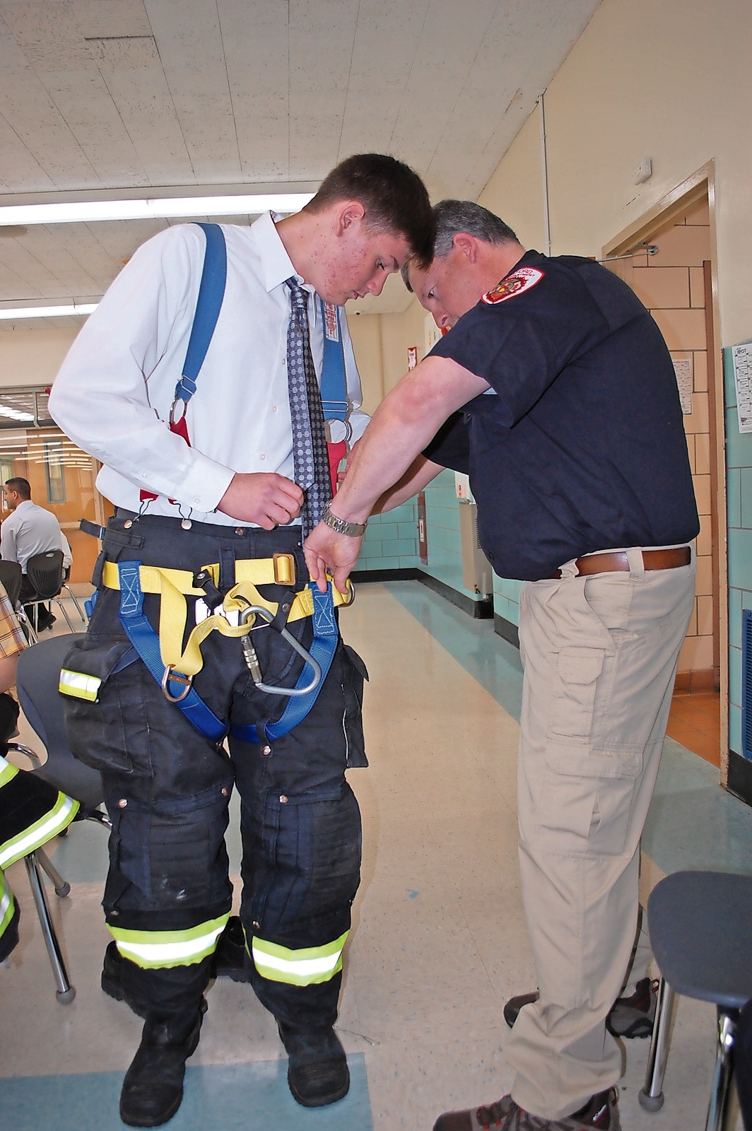 Seaford firefighter George Kern helped eighth-grader Anthony Sand try on the gear.
