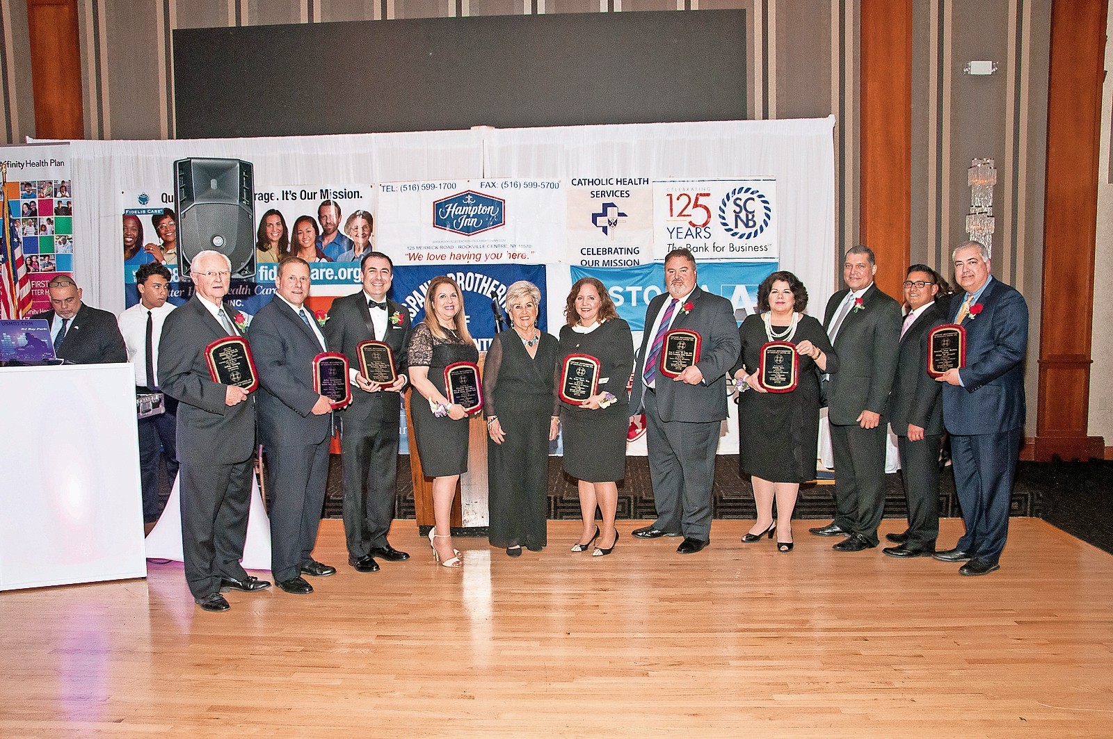 The Hispanic Brotherhood honored many people for their contributions to the community. From left are the Honorable Tom Glynn, Rockville Centre Police Commissioner Gennario, Dr. David Rose, Elizabeth Custodio, Hispanic Brotherhood Director Margarita Grasing, Betty Lugo, Esq., Jorge Gardyn, the three honorees from Fidelis Care, and the Honorable Jorge Martinez.