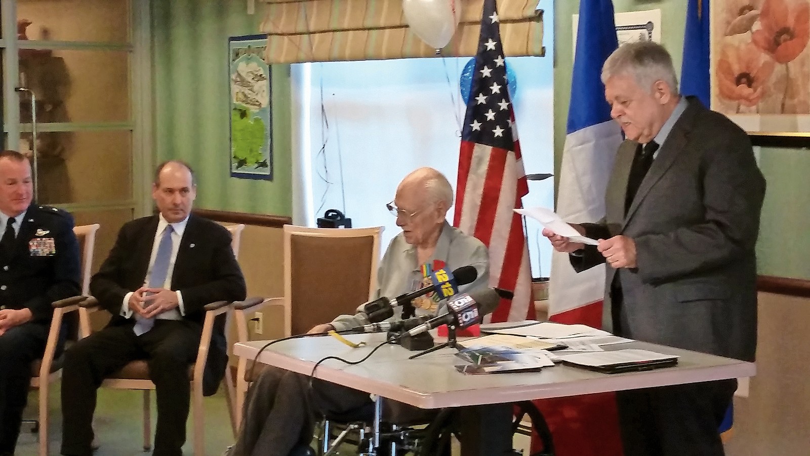 Bruce Smith, far right, speaking to his father about his D-Day honor with General Owens and Colonel Frédéric Vigneron listening