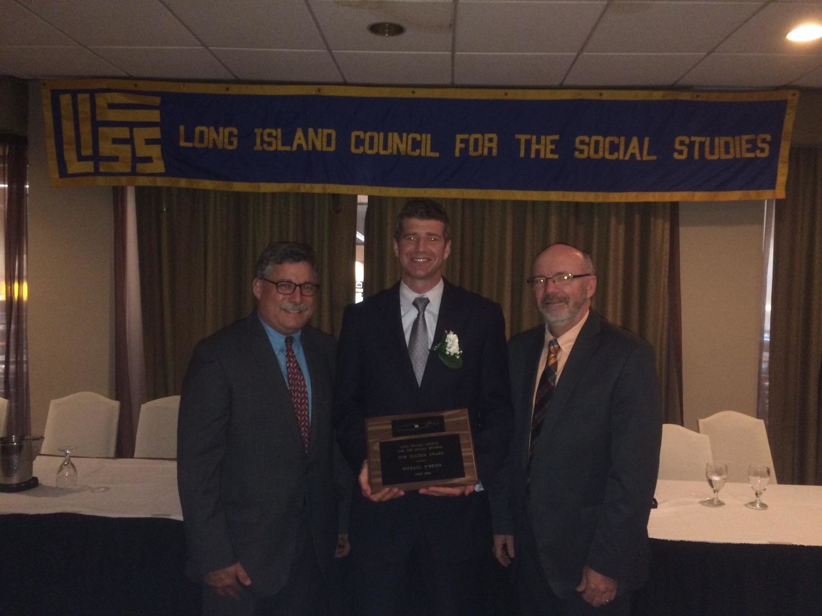 South High School teacher Michael O’Brien, center, was named 2016 New Social Studies Teacher of the Year by the Long Island Council for the Social Studies. He is pictured with South High’s social studies chair, Michael Serif, and LICSS President Brian Dowd.