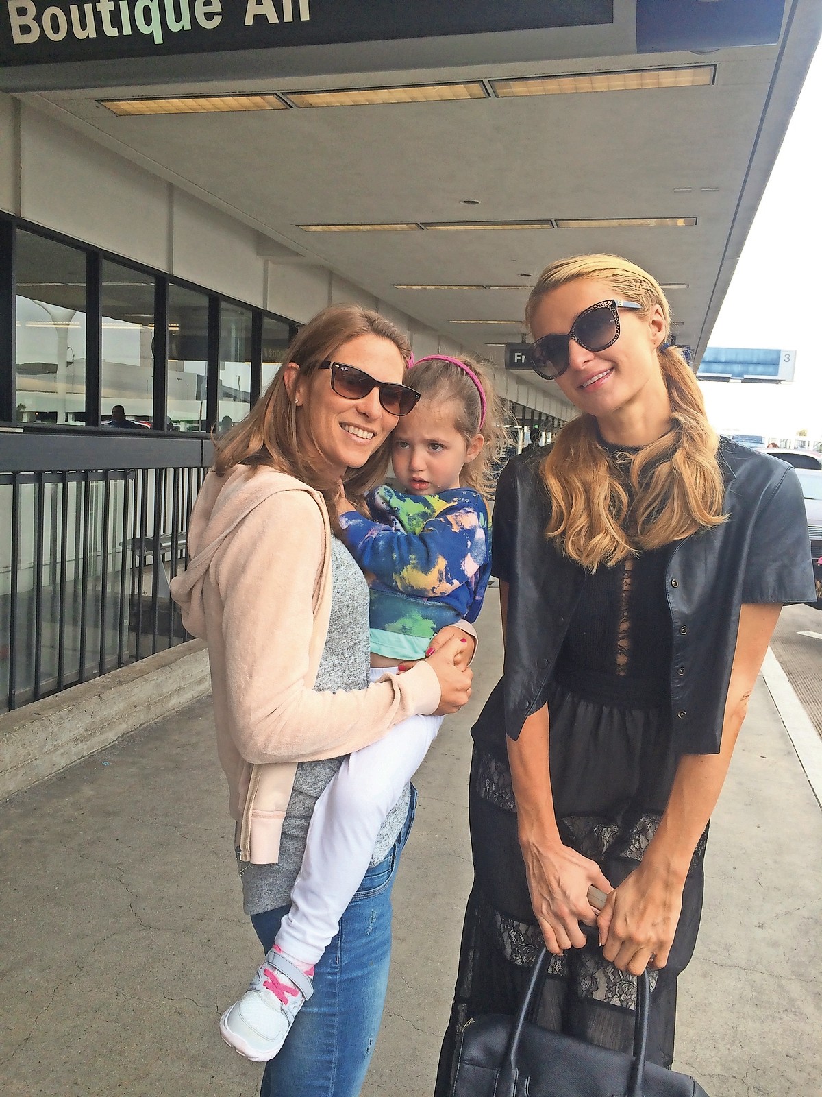 Paris Hilton, right, tried to cheer up Long Beach residents Sam and Jessica Pinto’s daughter, Zoey.