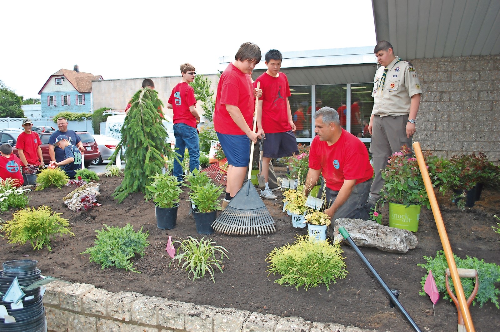 Boy Scout John Vaiano, far right, supervised his fellow Scouts who planted bushes and flowers outside the Wantagh Public Library on June 11.