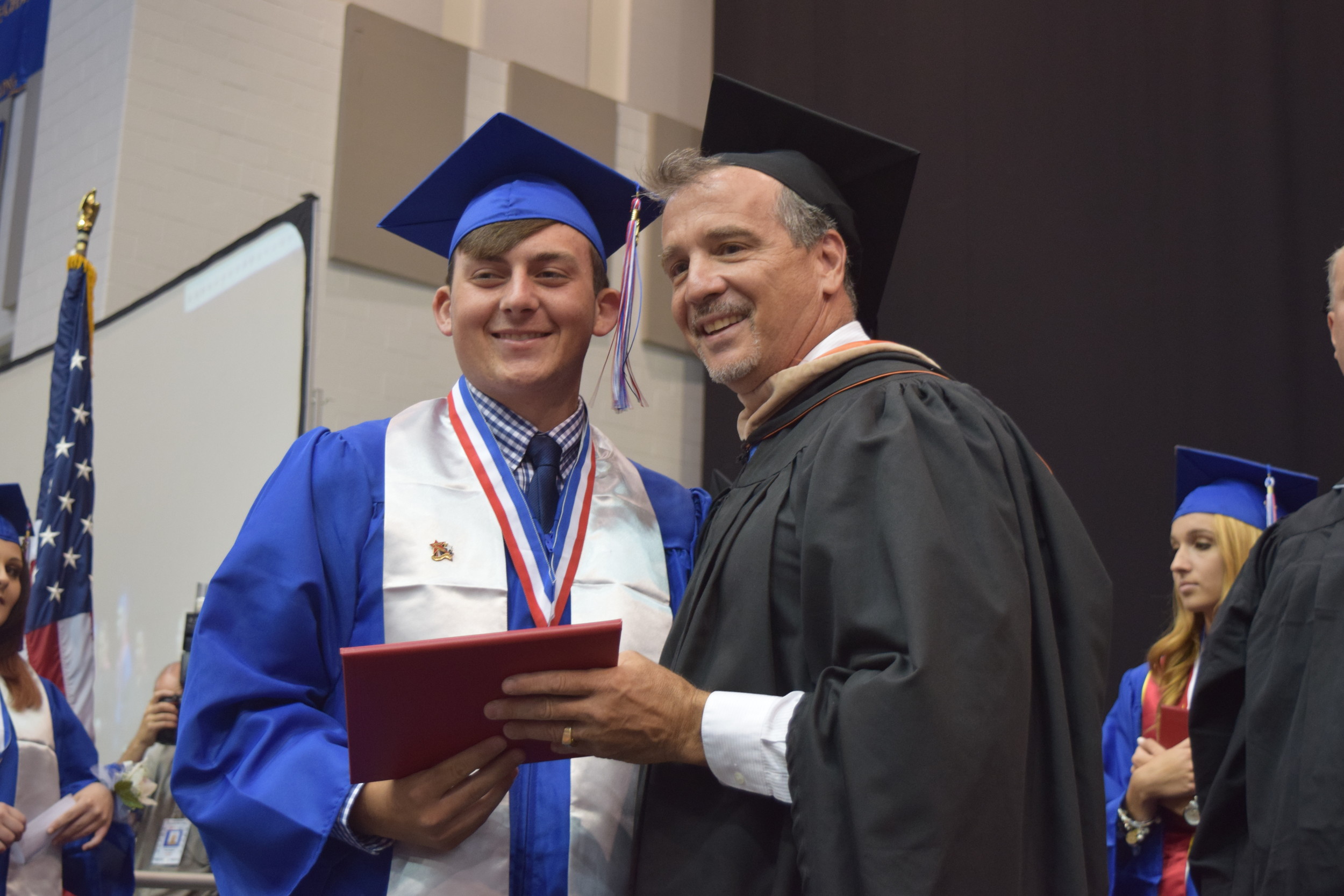 Board of Education Trustee Michael Pappas presented Justin Norcini with his diploma.
