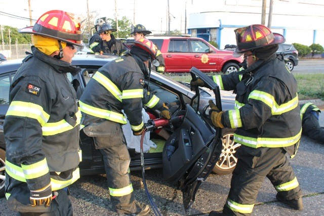 Lynbrook firefighters cut off a car door to rescue an injured passenger after a two-car collision at the intersection of Merrick Road and Ocean Avenue.