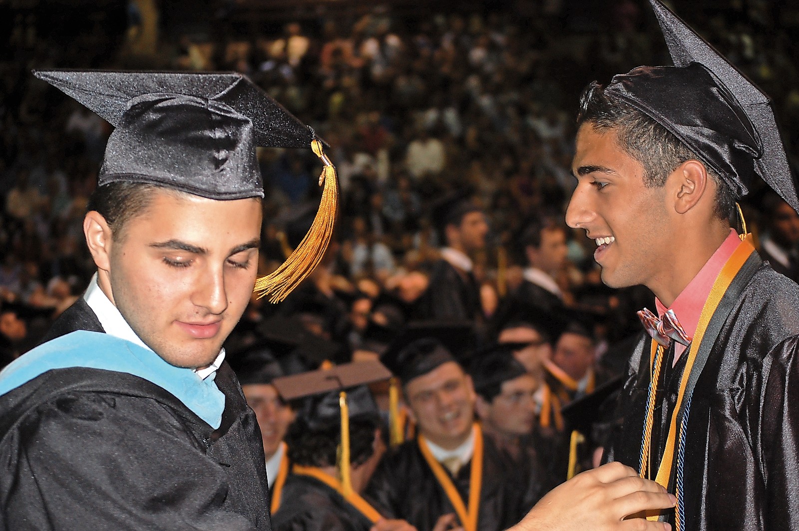 Board of Education Trustee Peter Mountanos, left, presented a graduation medal to his brother, Chris.