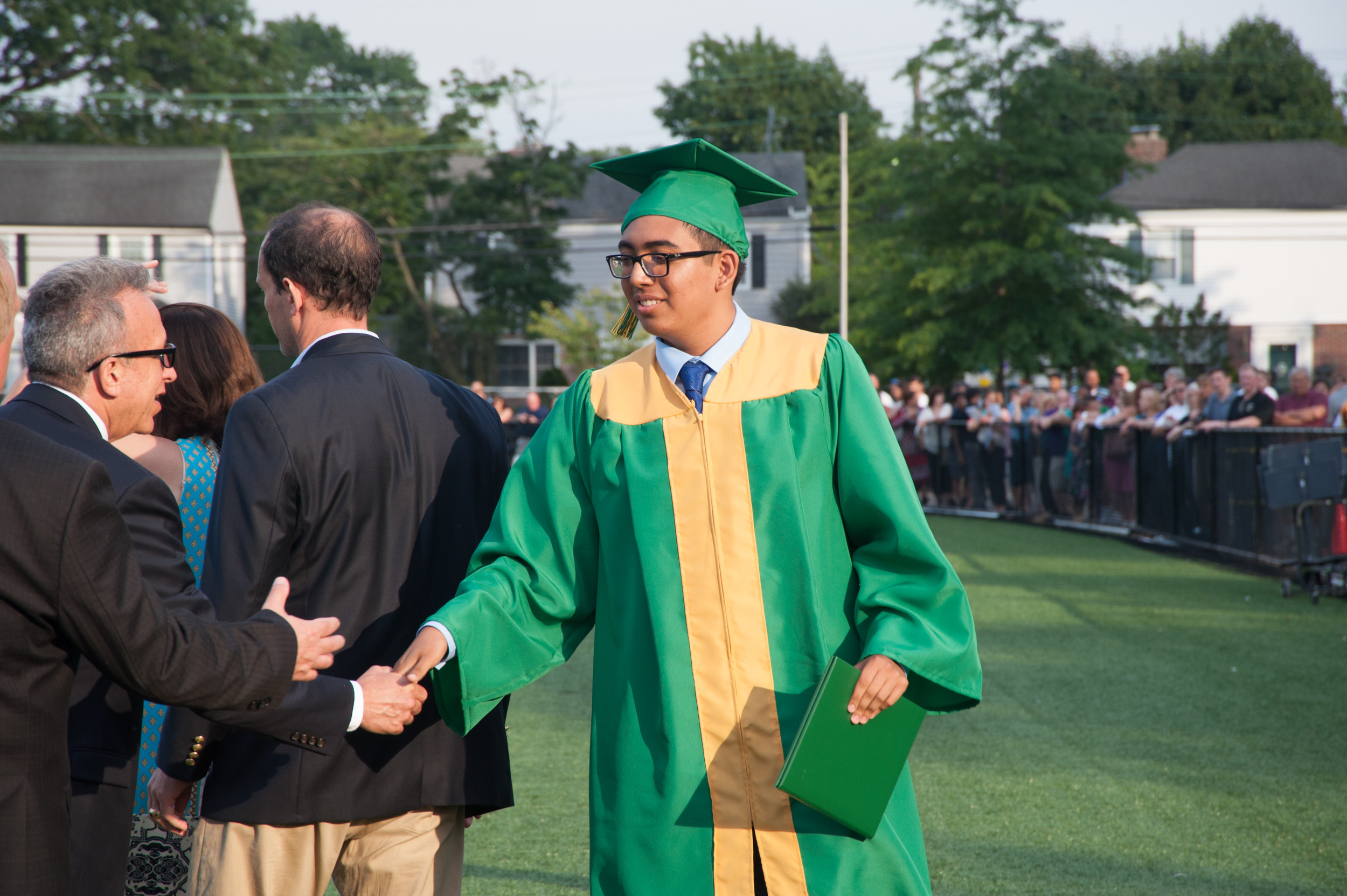 A graduate was congratulated after receiving his diploma.