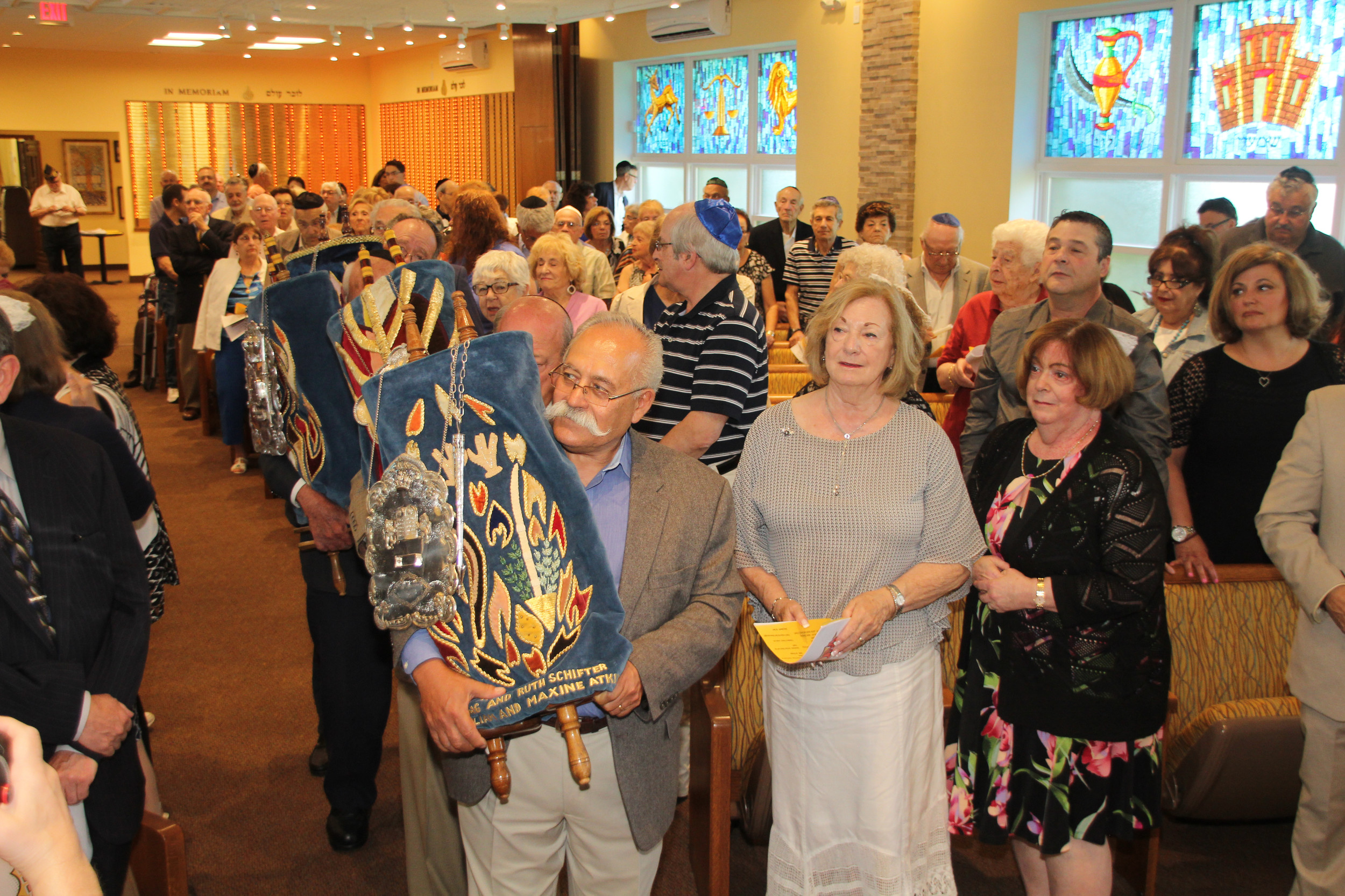 Members of Congregation Beth Tikvah brought the Torahs up to the Holy Ark at the dedication ceremony for the remodeled sanctuary last Sunday evening.