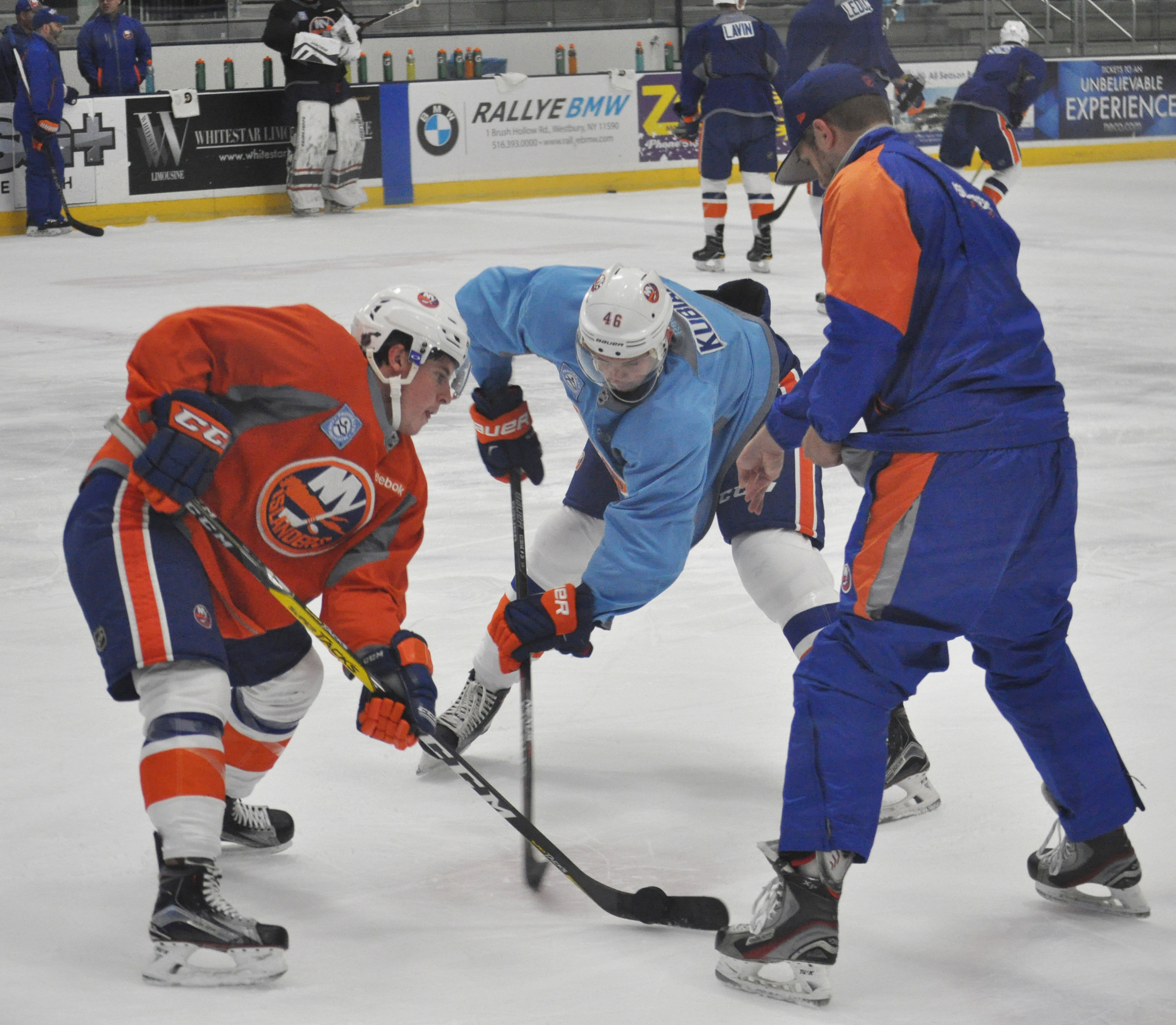 Travis St. Denis, left, and Jeff Kubiak worked on faceoffs during Isles' mini-camp practice on June 29.