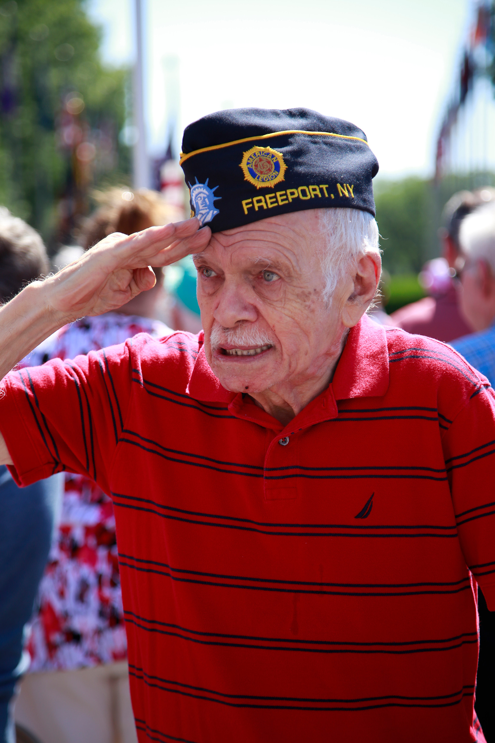 Robert Pachas, a Freeport resident and Korean War veteran, saluted during the singing of the National Anthem.