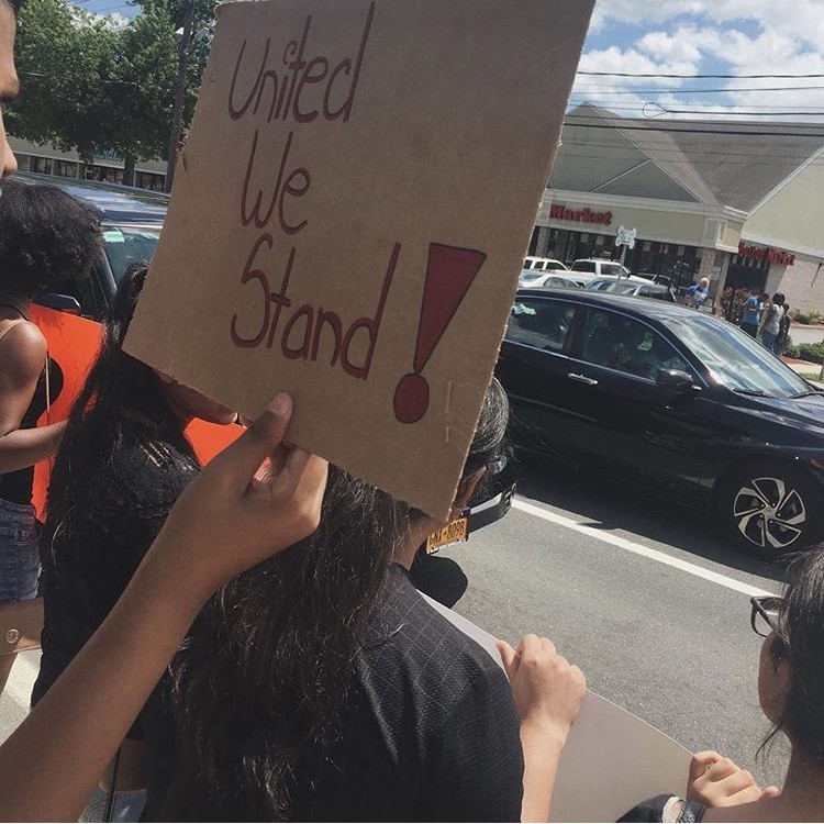 Demonstrators held signs in front of Chase Bank on West Merrick Road. They marched there from Central High School on Monday.