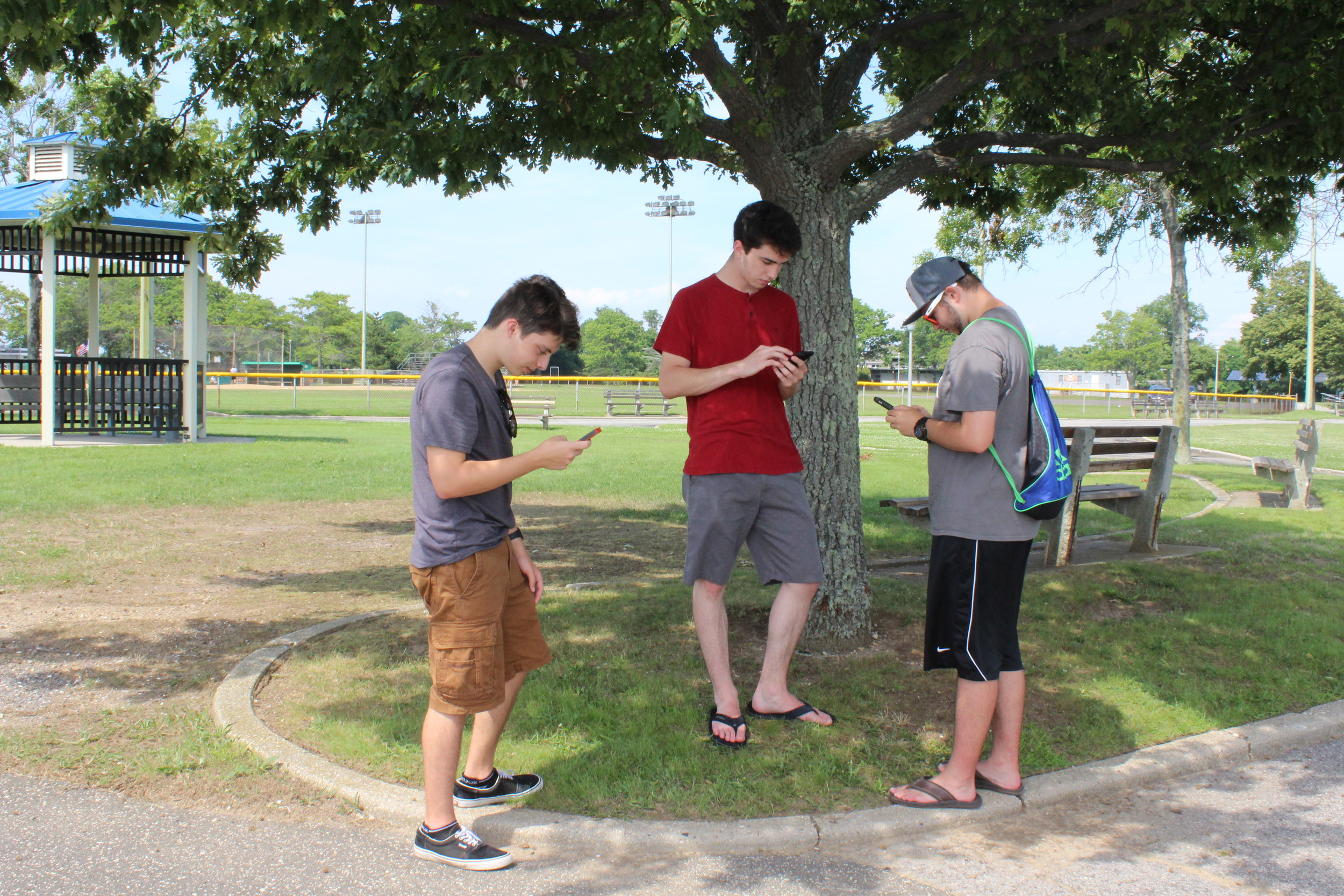 Nick Bonfiglio, Far left, Evan Bartlett and Cory Levy, all of Seaford, tried to catch Pokémon using the new Pokémon Go smartphone app at Seaman’s Neck Park last week.