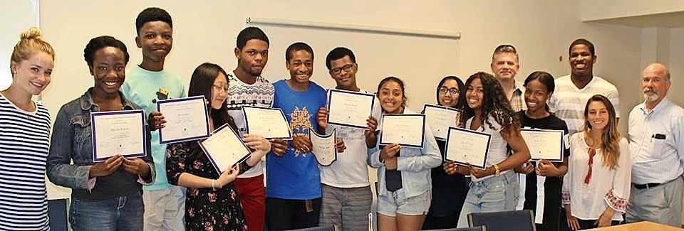 Hofstra Summer Institute students received Certificates of Merit for their participation in the program. From left were program mentor Courtney McGee, participants Mikelley Baptiste, Rex Asabor, Jayne Chen, Rodney Legrand, Nsikak Ekong, Michael Bailey, Esly Rodriguez, Fatima Bhutta and Karyse Gocoul, Professor Scott Brinton, participant Amoy Brown, mentors Nakeem Grant and Danielle Agoglia and, Professor Peter Goodman.