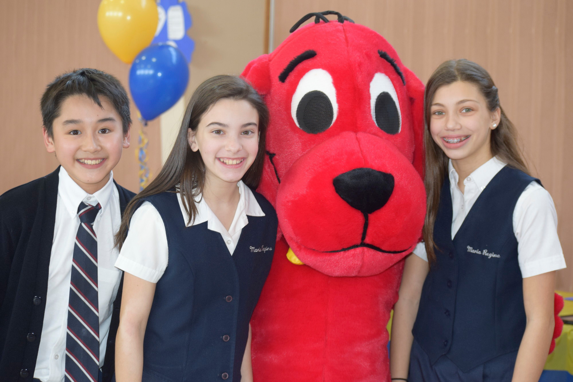 Daniel Hoang, 12, far left, Kimmy Purcell, 12, and Jamie Barrett, 12, had fun with Clifford the Big Red Dog at Maria Regina School’s open house last January.