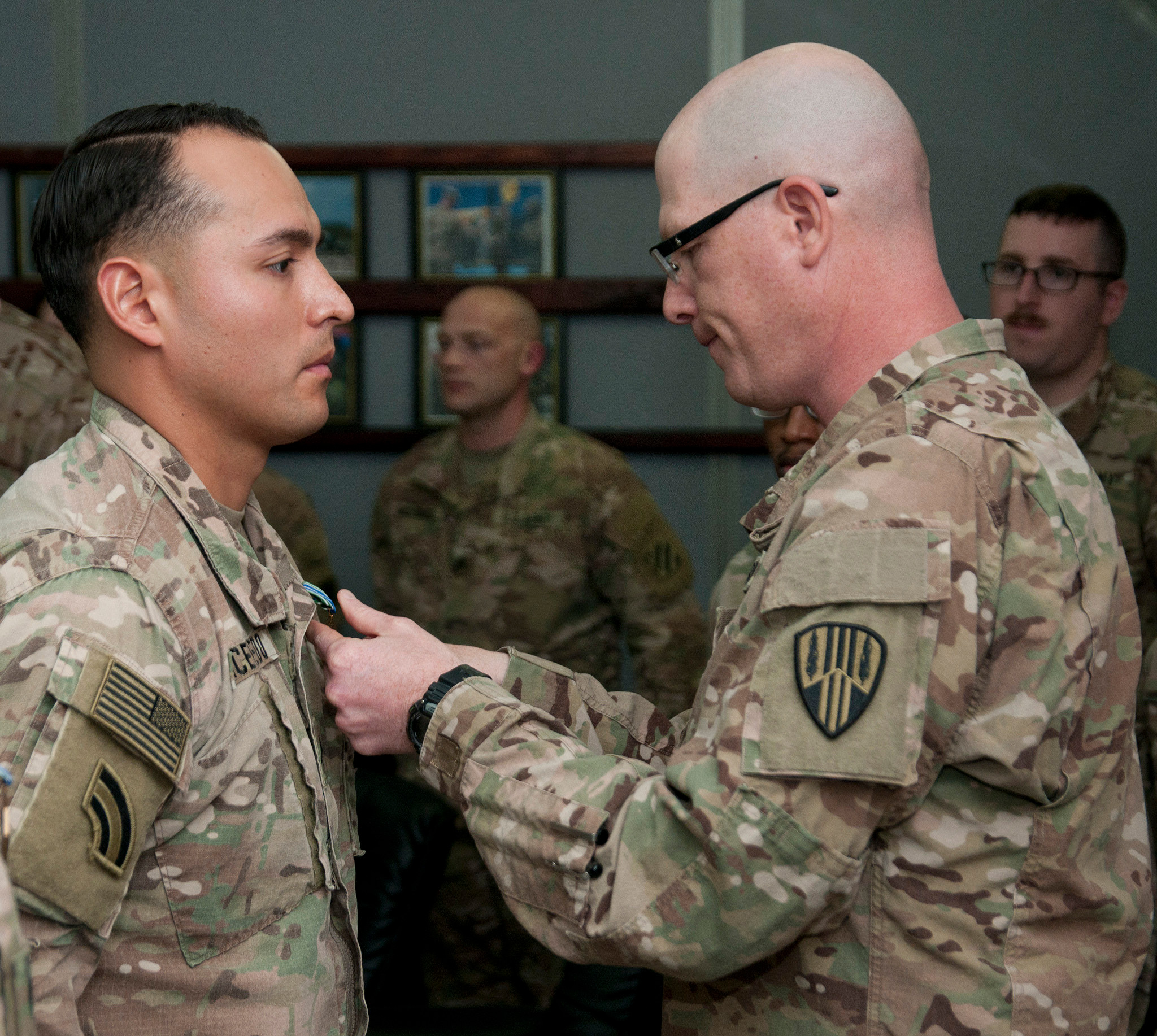Col. Stephen Bousquet, right, commander of the 369th Sustainment Brigade, presented an Army Achievement Medal to Sgt. Damian Acevedo, of Valley Stream, during a ceremony at Camp Arifjan, Kuwait on Jan. 14.
