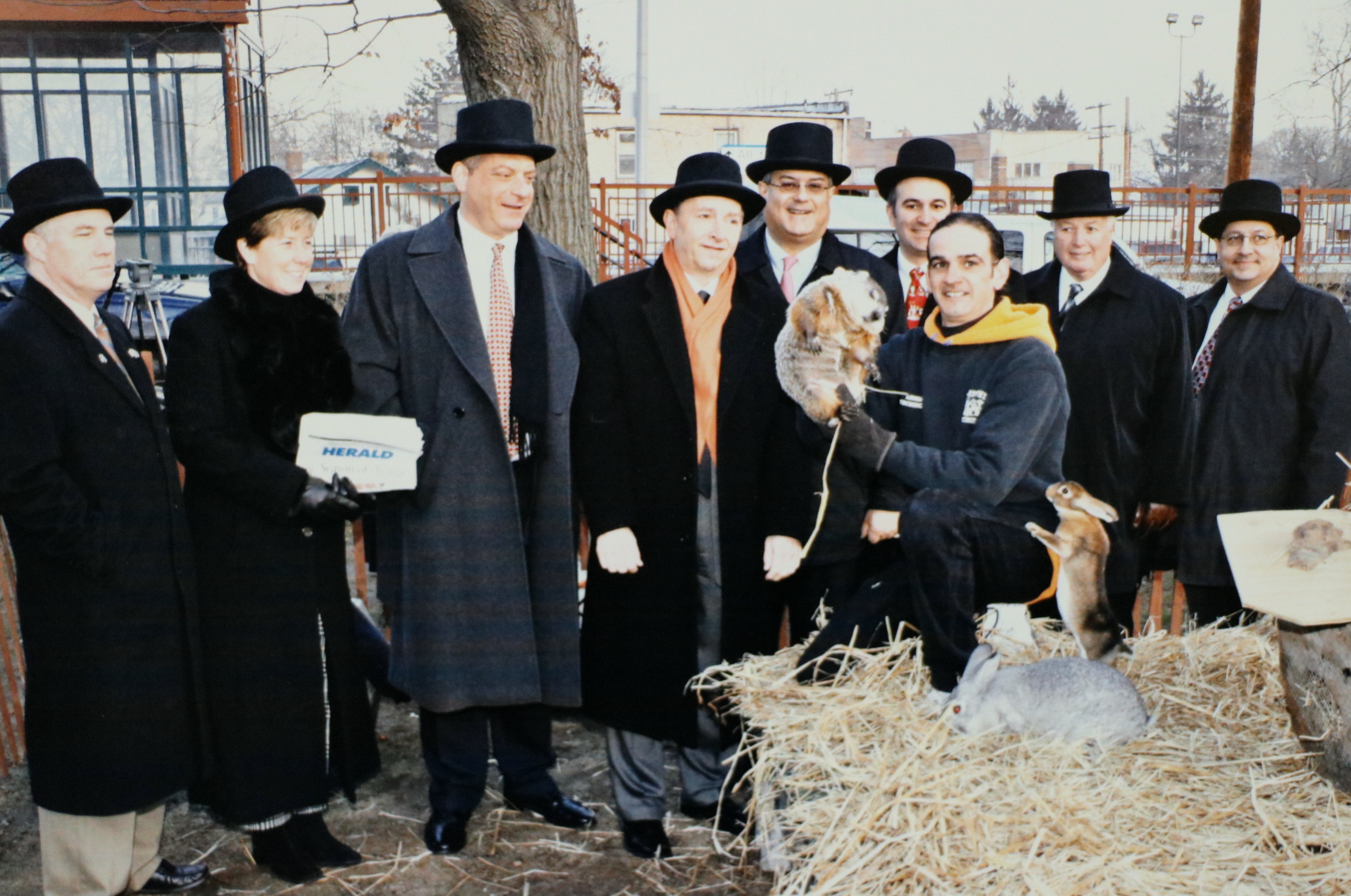 Groundhog Day 2004 in Malverne. From left: past village Trustee William Malone; current Mayor Patti Ann McDonald; Herald Publisher Cliff Richner; past Mayor Anthony Panzarella; current Town Supervisor Anthony Santino; past Deputy Mayor James Callahan; Mel handler  Andre Ricaud; past Village Justice James W. Dougherty; and past Lynbrook trustee David Penzo.