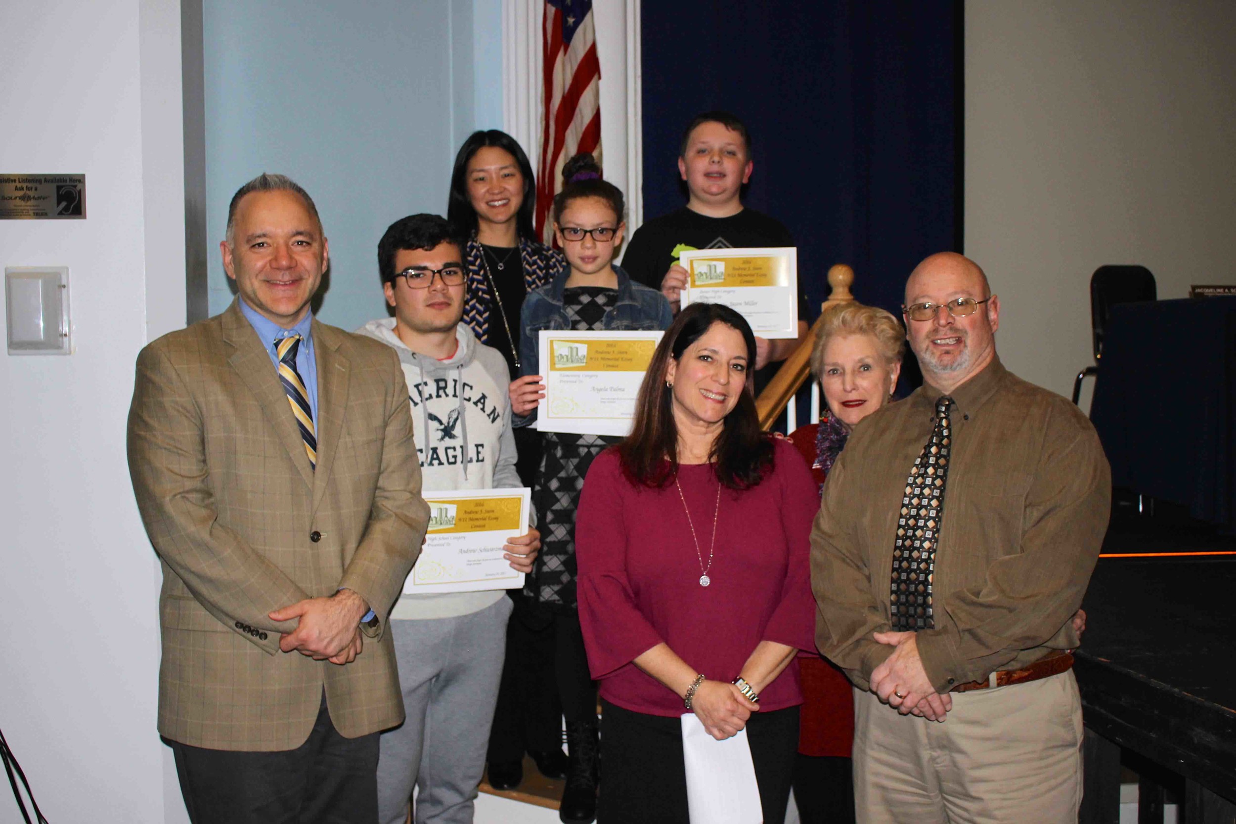 Andrew Stern Memorial Essay Contest winners Andrew Schwarzman, second from left, Jason Miller, center, and Angelina Palma , fourth from left, were honored by East Rockaway Junior-Senior High School Principal Joseph Spero, Centre Avenue School Principal Sherry Ma and members of the Stern family.