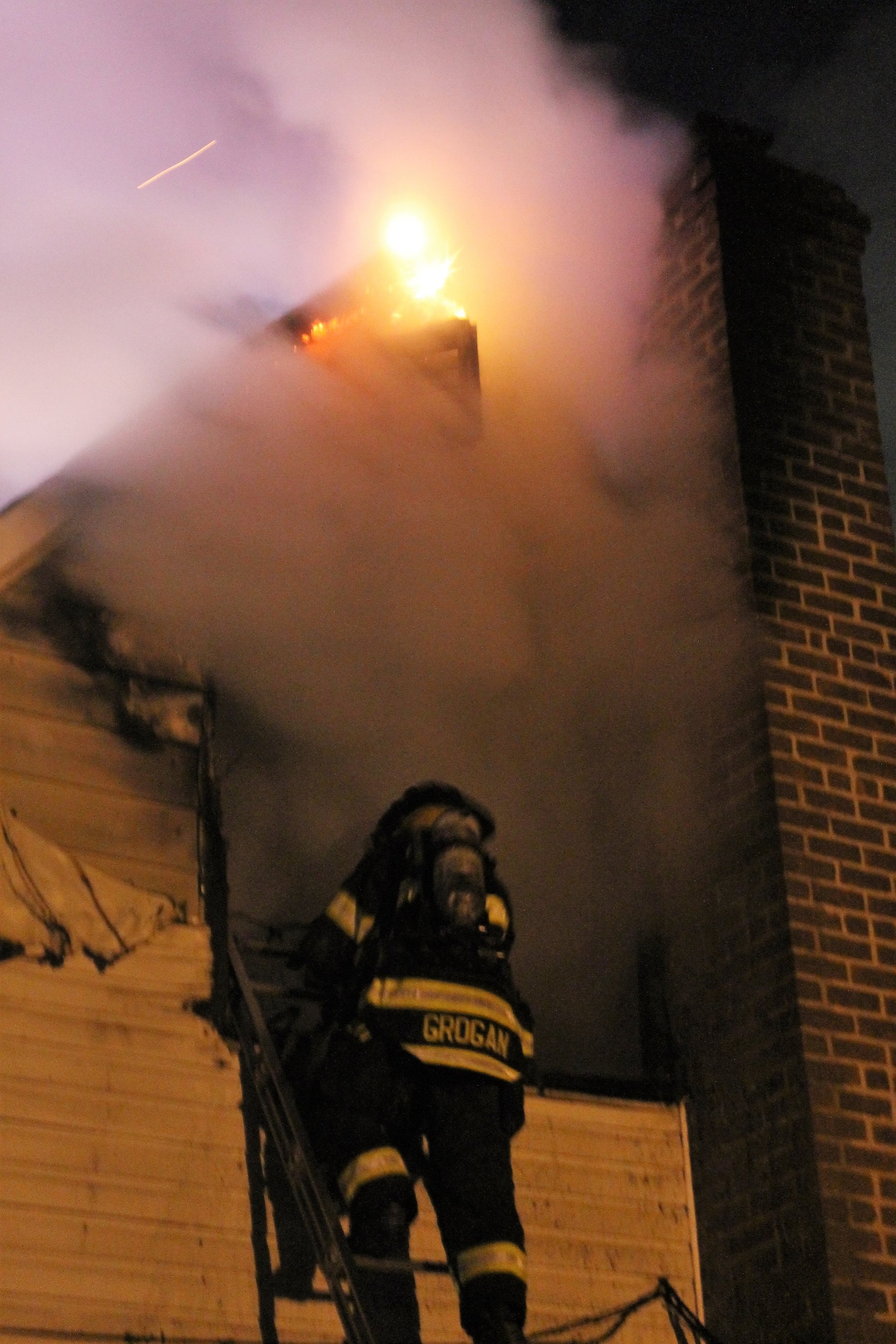 A firefighter scaled the side of the home to tend to the second story fire.