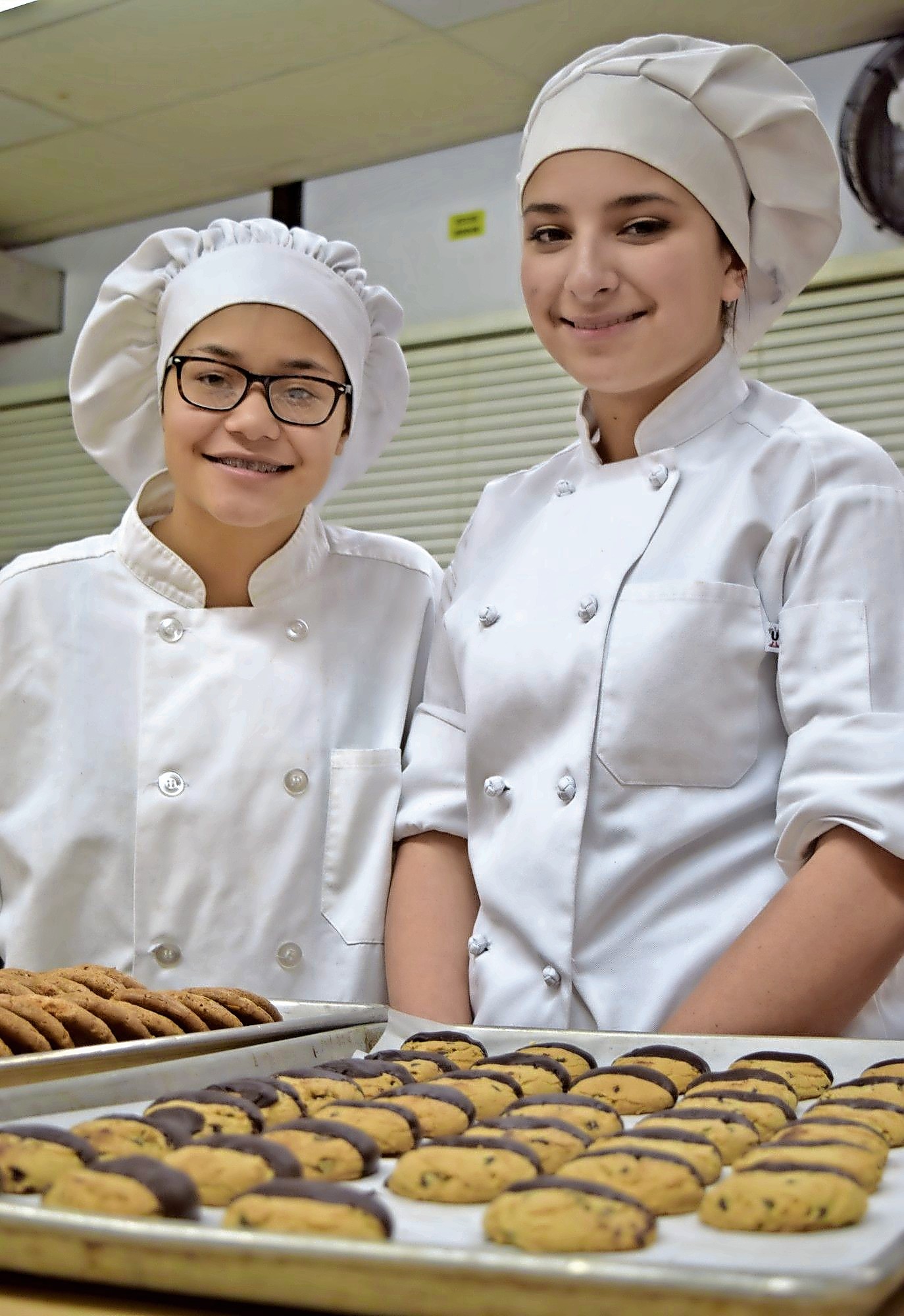 MacArthur High School students Zulema Duran, left, and Sarina Aviles showed off their culinary skills at a GC Tech open house last January.