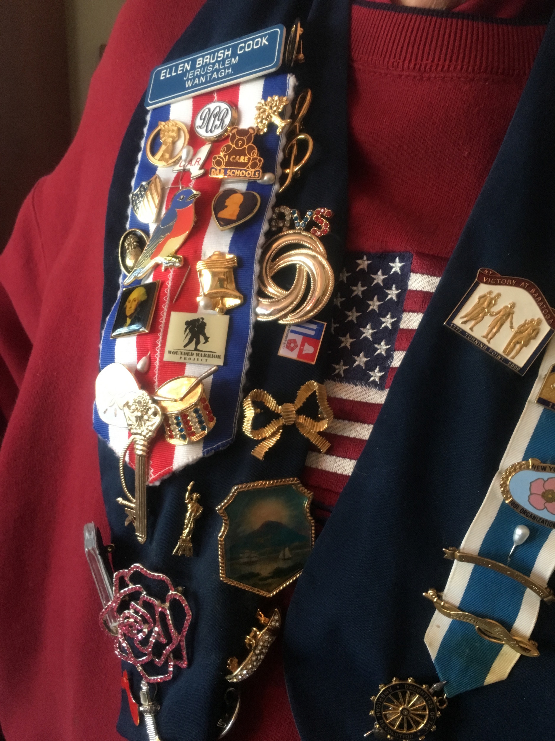DAR members wear pins that signify their connection to different places and points in history.