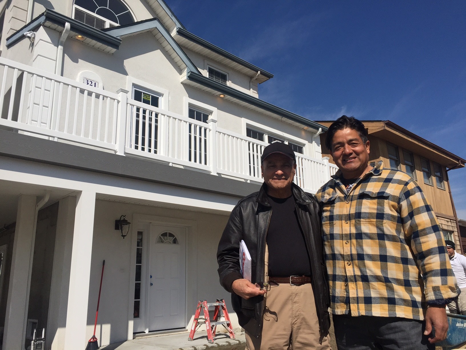Len Torres, president of the City Council, with his contractor, Edwin Verastegui, right, outside his elevated home on East Market Street last week.