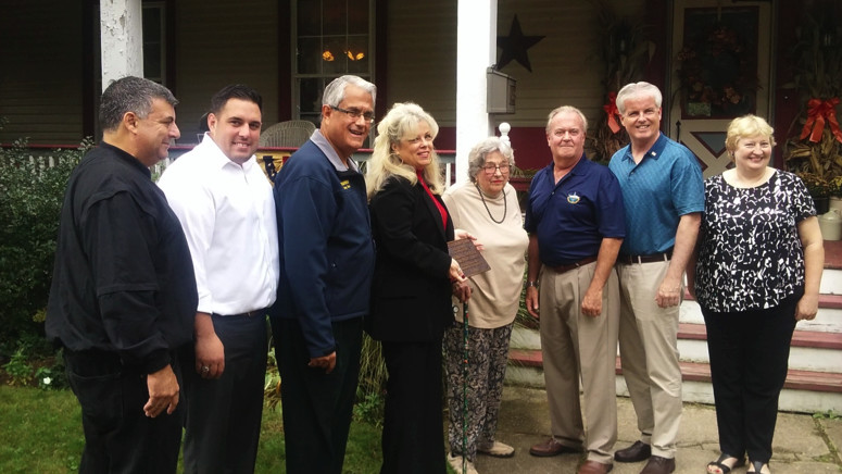 East Rockaway Mayor Bruno Romano, left, Councilman Anthony D’Esposito, Town of Hempstead Supervisor Anthony Santino, Historical Society of East Rockaway and Lynbrook President Patricia Sympson, Trustee Gordon Fox, Chris McGrath and Historical Society of East Rockaway and Lynbrook Executive Director Madeline Pearson presented Ellen Morrison with a plaque to commemorate the homestead’s addition to the National Register of Historic Places in October.