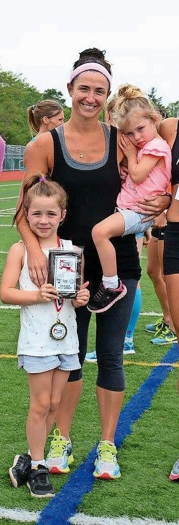 Kelly Perno-Grosser with her daughters, Bridget, 7, and Charlotte, 4, after she won the Runner’s Edge Long Island Women’s 5K in Farmingdale last year.