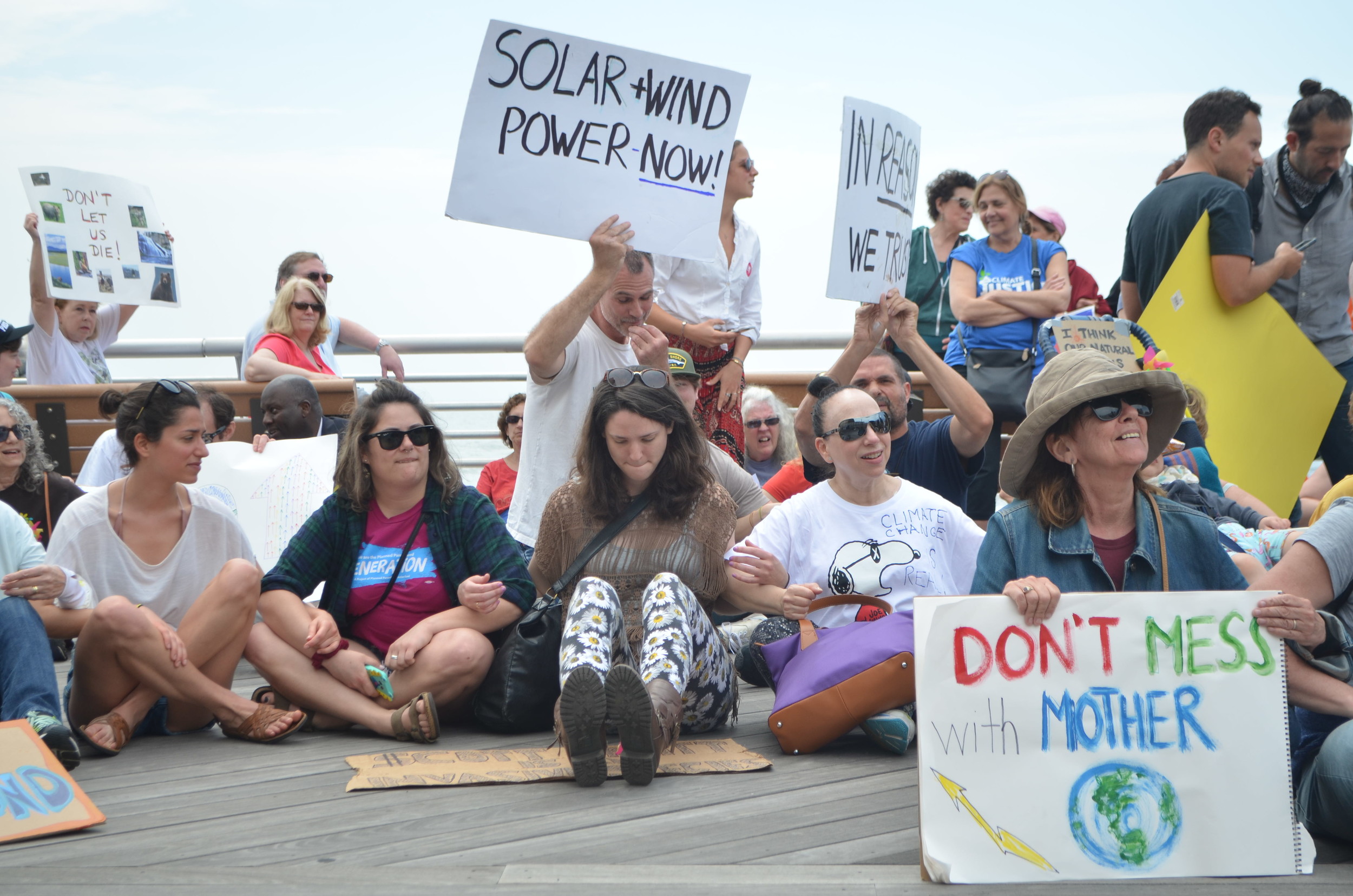 Organizers of the event asked protesters to sit down on the boardwalk, link arms and observe a minute of silence — as did participants in other marches around the country.