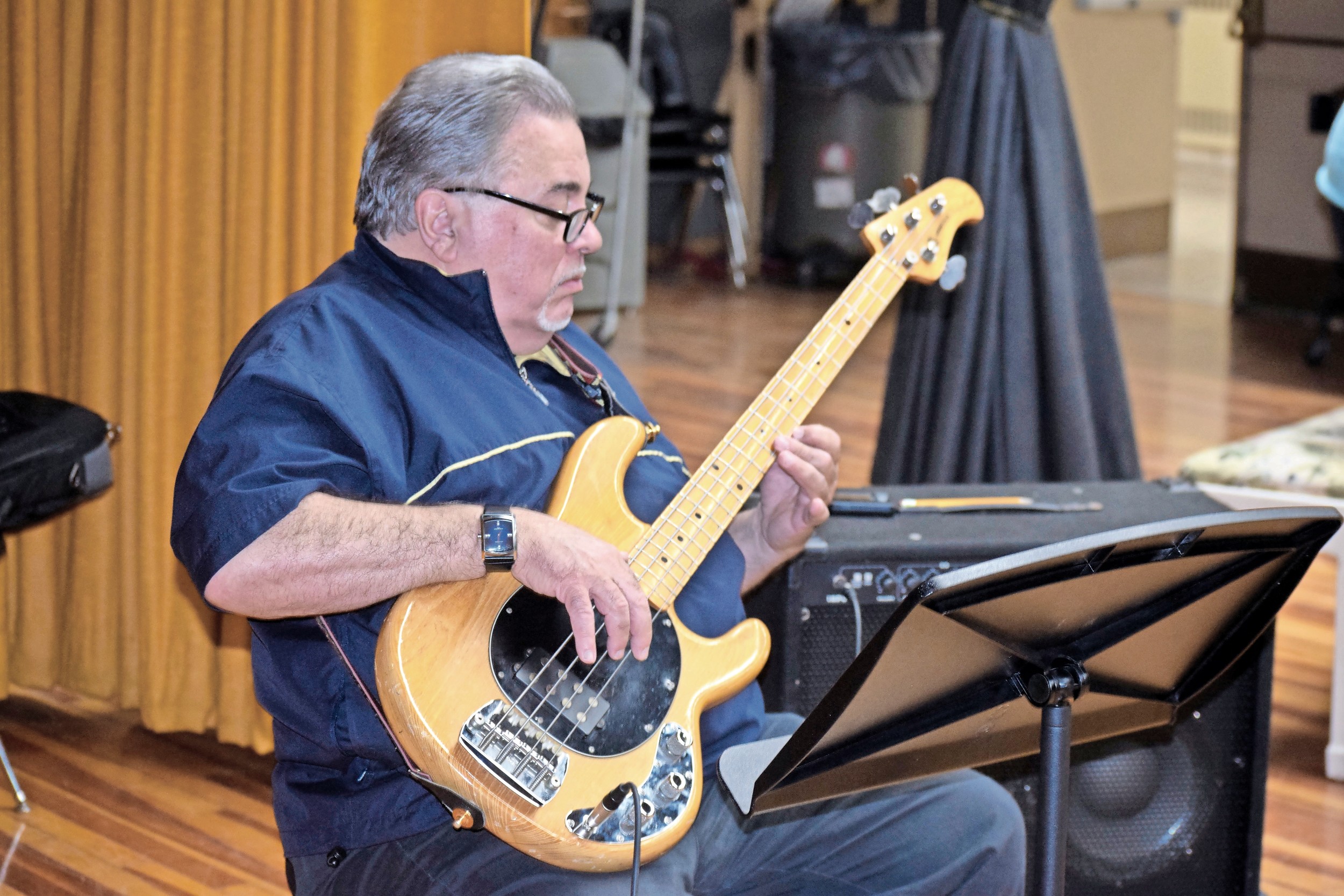 Cliff Heepe, a longtime member of the band, tuned his guitar for the spring concert.
