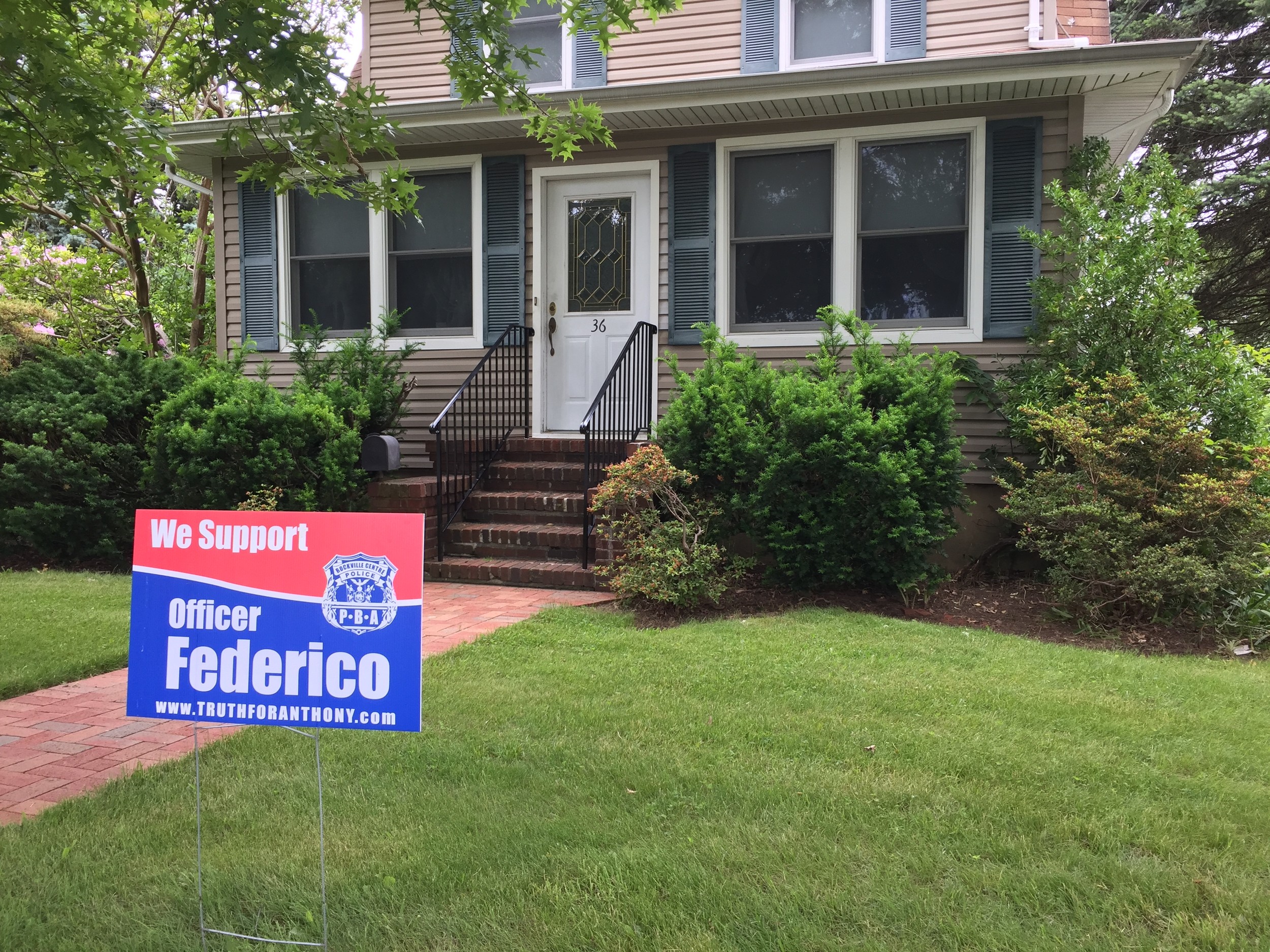 Lawn signs showing support for Officer Anthony Federico are in yards throughout the village and in surrounding communities.