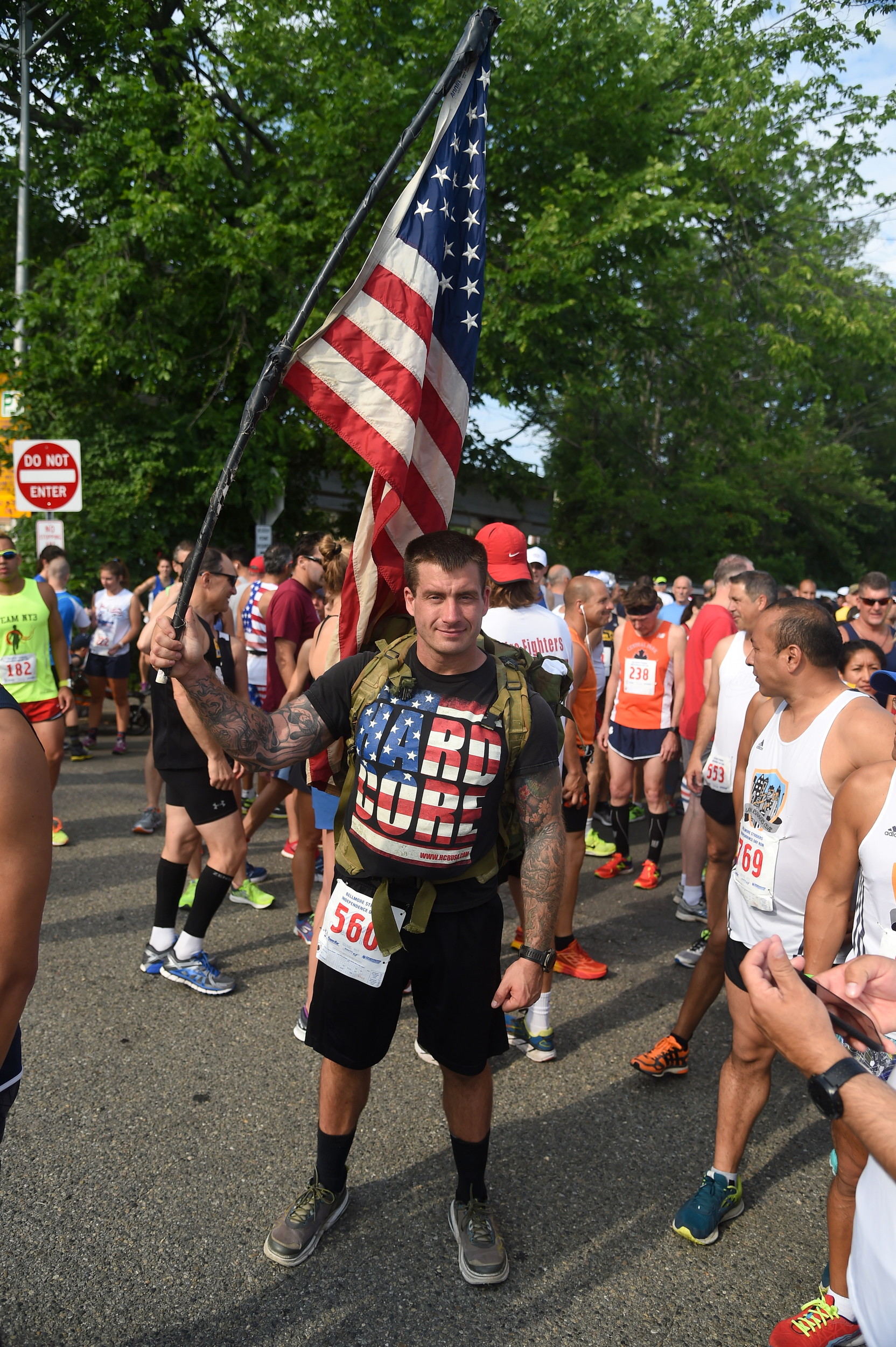 Billy Richards, a U.S. Marine from Islip, hoisted the flag before the kick-off of the Independence Day run.