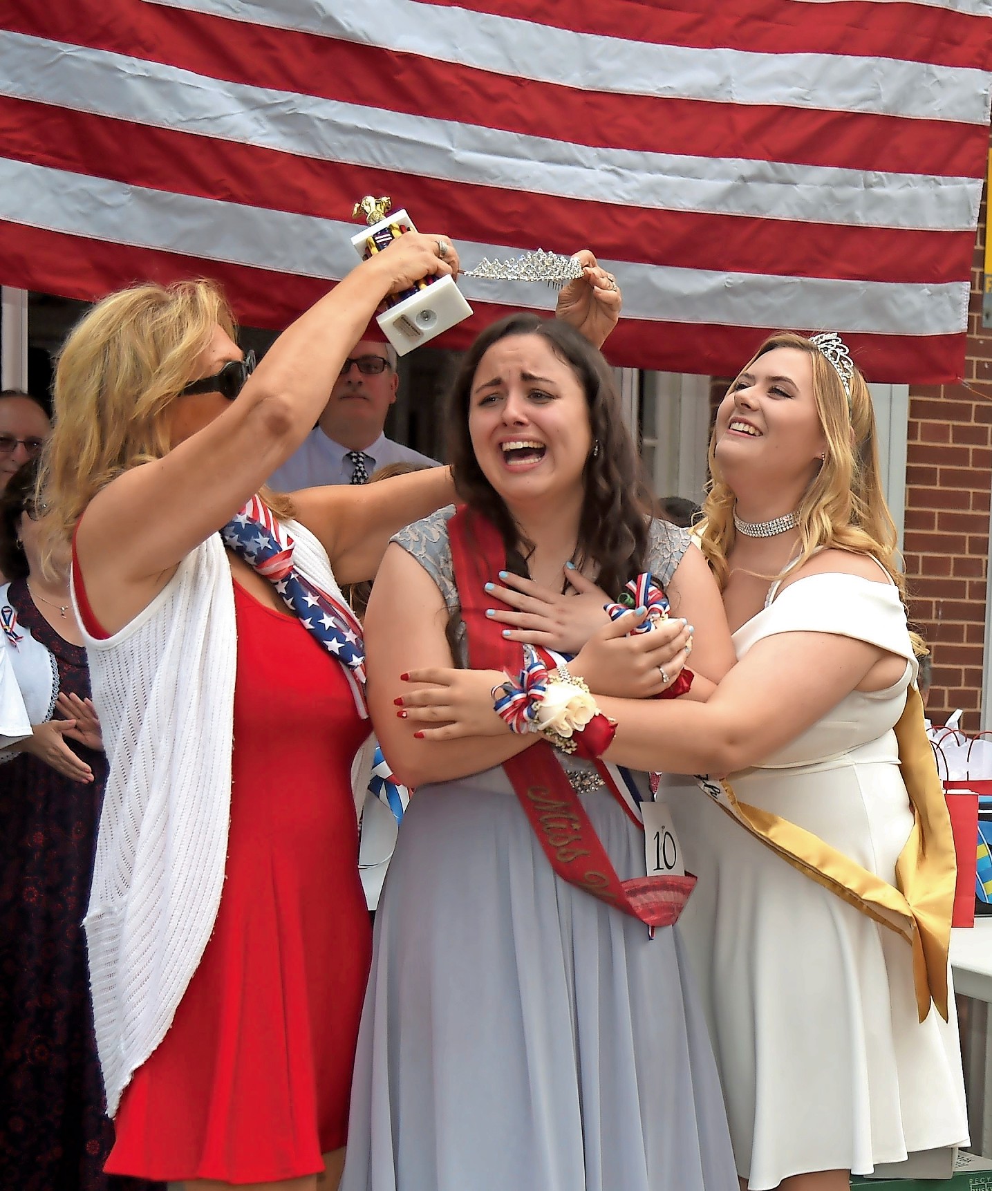 Samantha Walsh was crowned Miss Wantagh at Wantagh Elementary School on July 4. Former Miss Wantagh Emma Carey, right, and Director Ella Stevens embraced her.