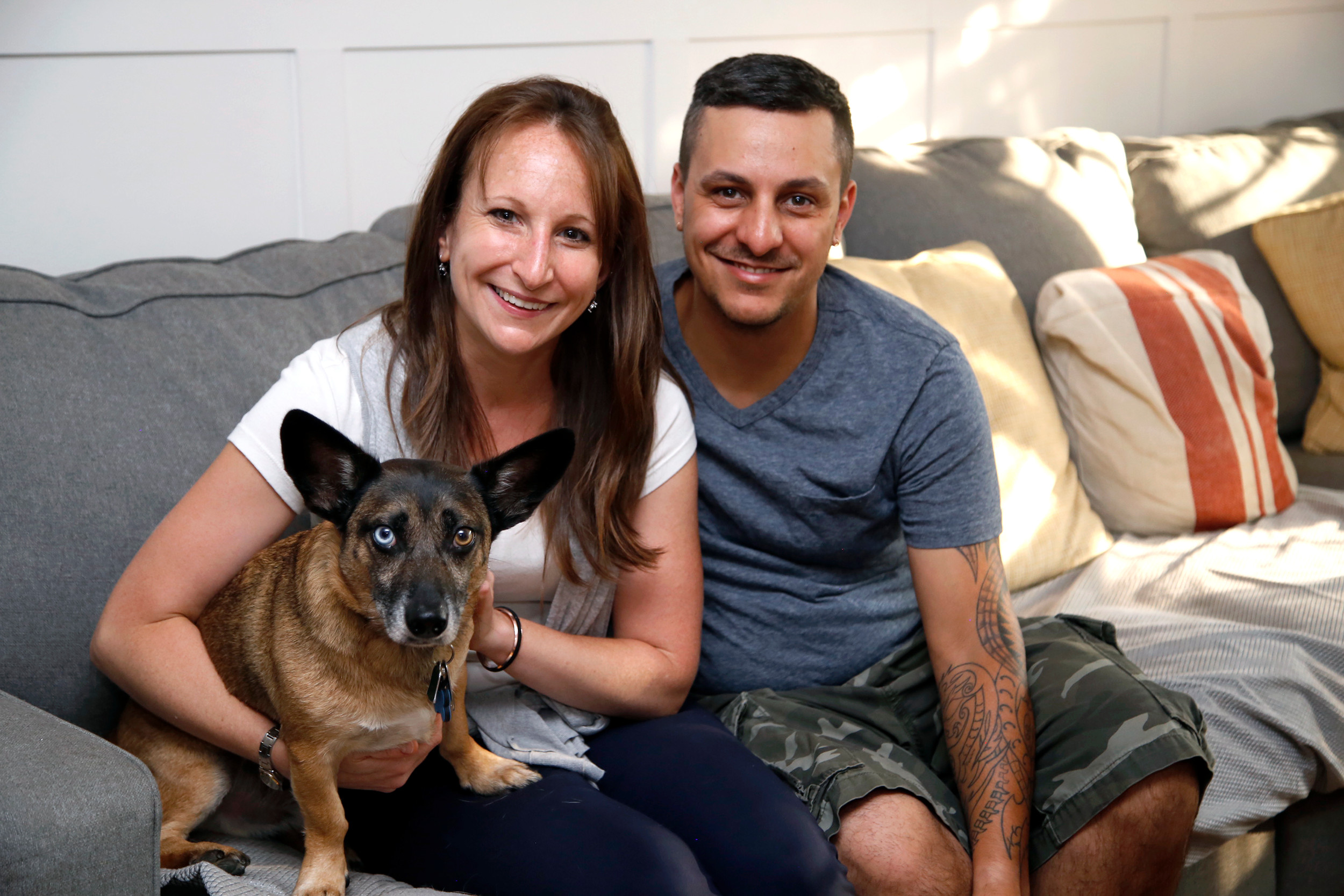 Veronica Silva, founder of Pawfect For You, with her husband Joey and their dog, JakeBear, in their Malverne home last week.