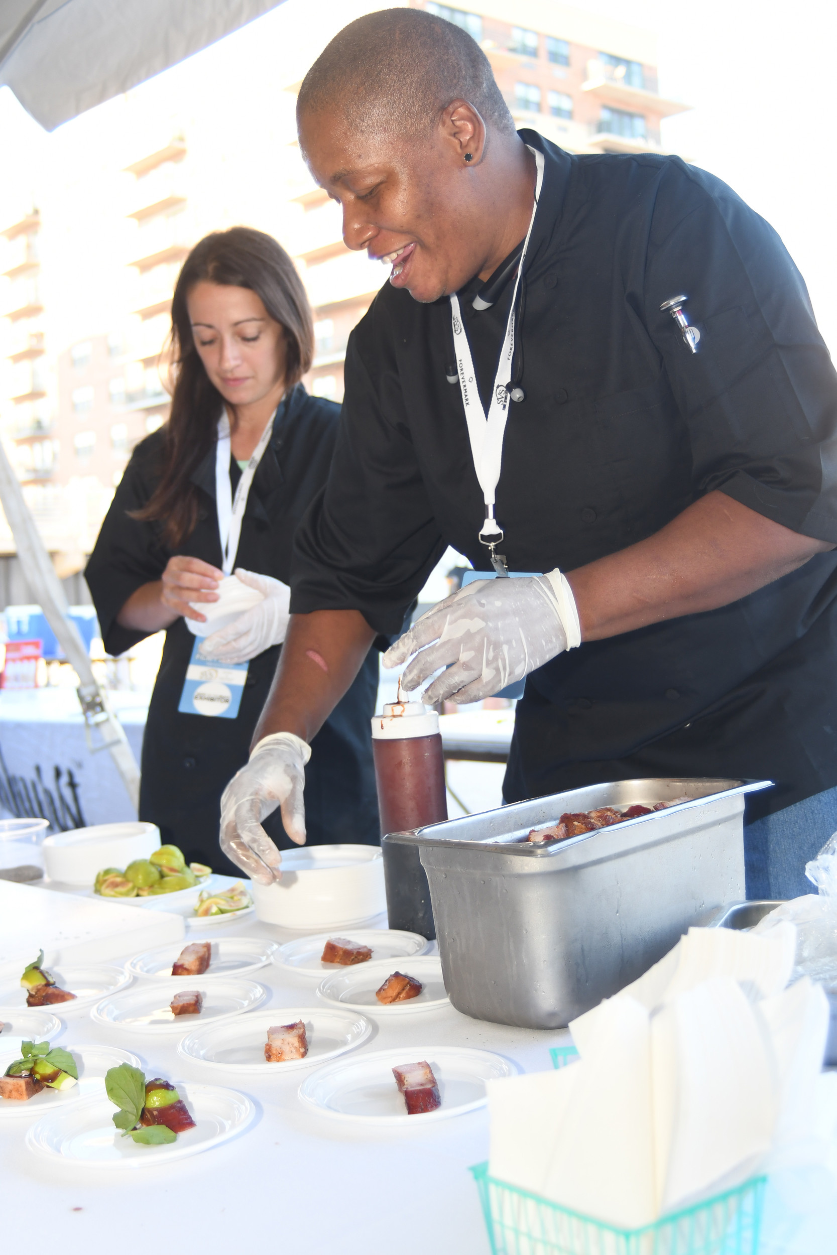 Jillian Leigh, left, and Tina Cruse of LB Social served candied bacon with black figs, watercress and a sherry fig reduction at Taste on the Beach.