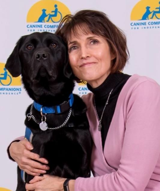Marianne Hutcheson, who conducts art therapy at Mercy Medical Center’s outpatient behavioral health services facility in Garden City, has help from Rally II, a trained assistance dog.