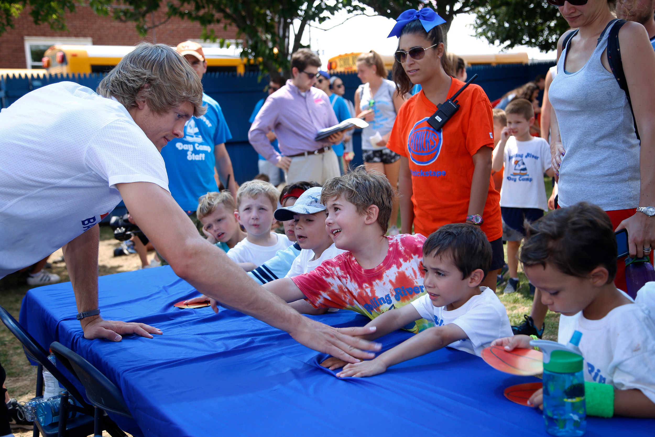 New York Knicks point guard Ron Baker signed autographs for children at Rolling River Day Camp on Aug. 11.