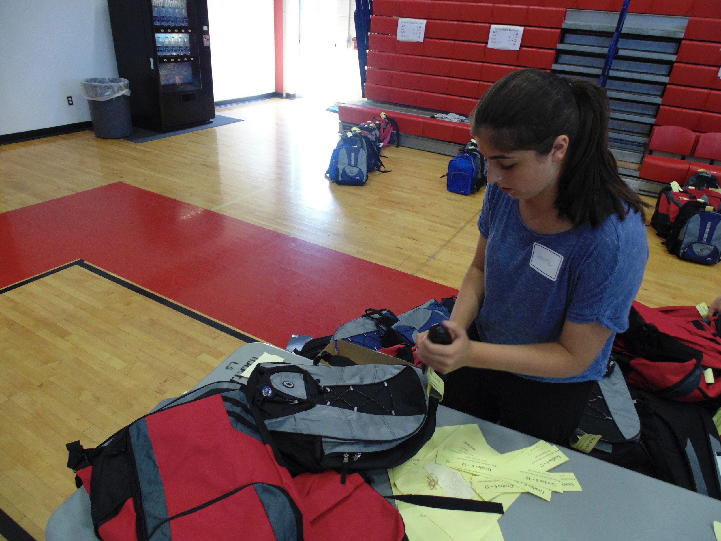 Tagging the finished packed backpacks to be sorted was 13-year-old Rebecca Aaron’s job at Supplies for Success.