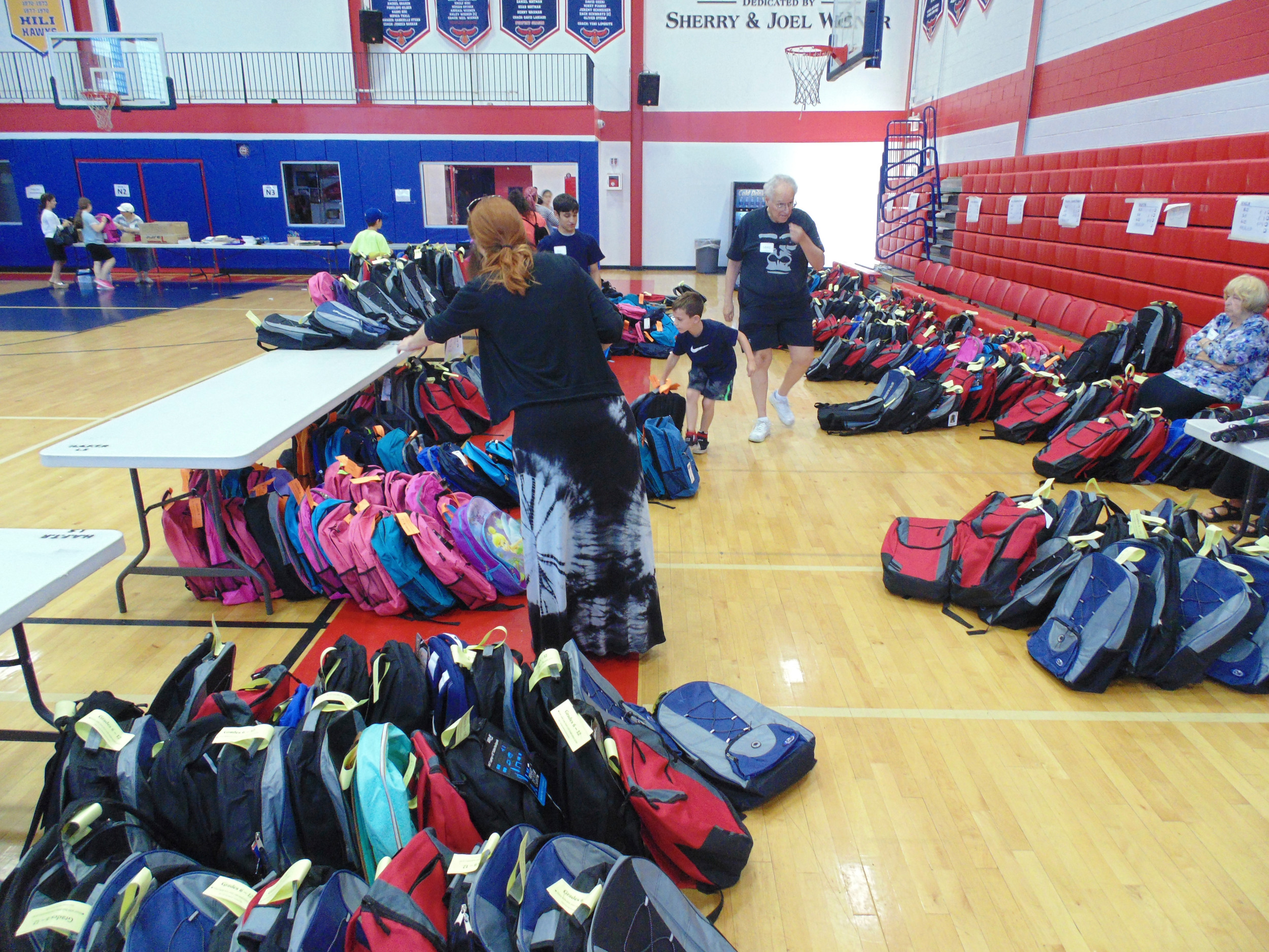 Hundreds of backpacks were packed and sorted and will now be distributed to students up to 12th grade.