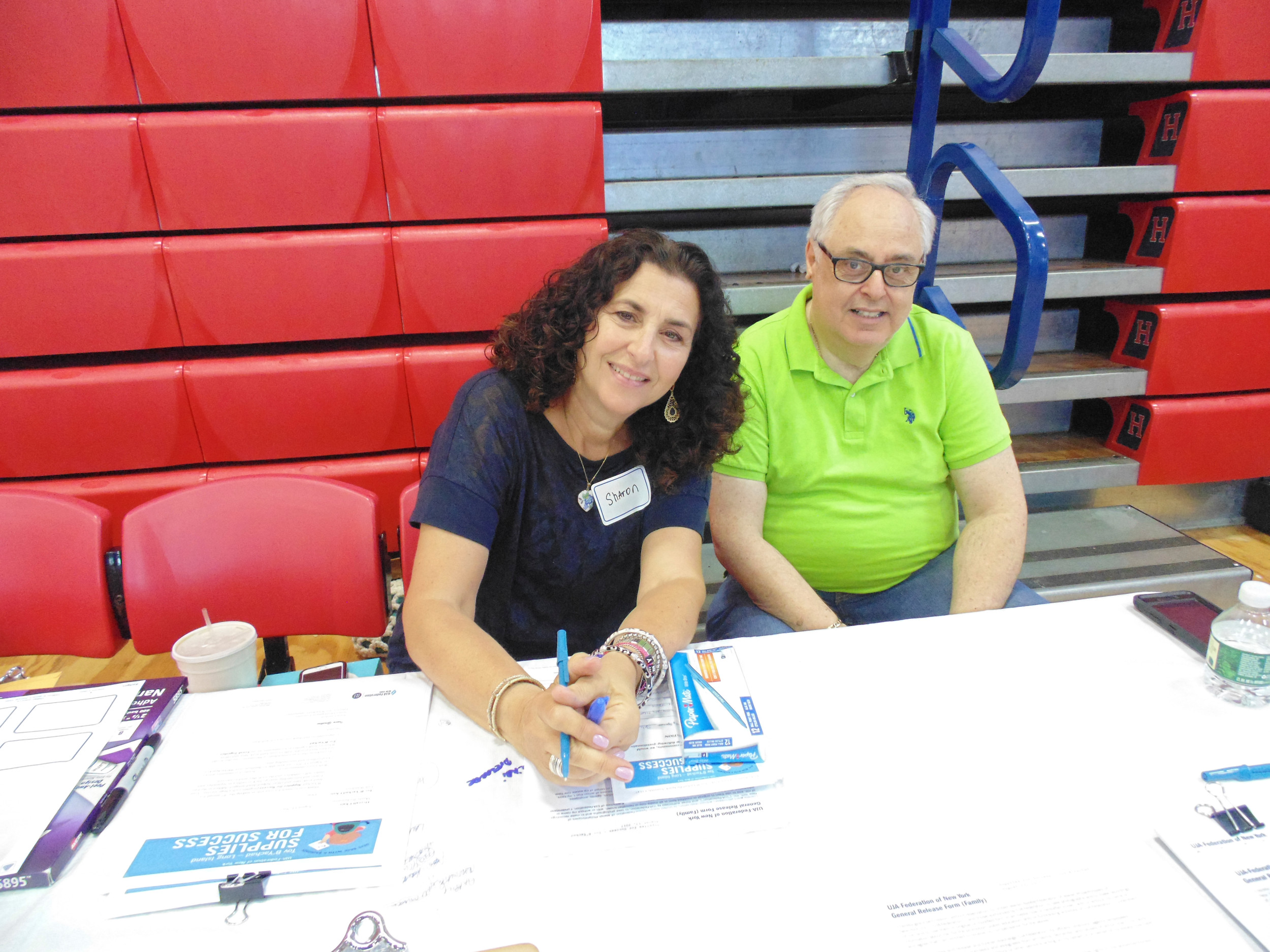 At the registration desk, Sharon Fogel and Irwin Gershon, helped the volunteers get organized at the Supplies for Success backpack packing event.