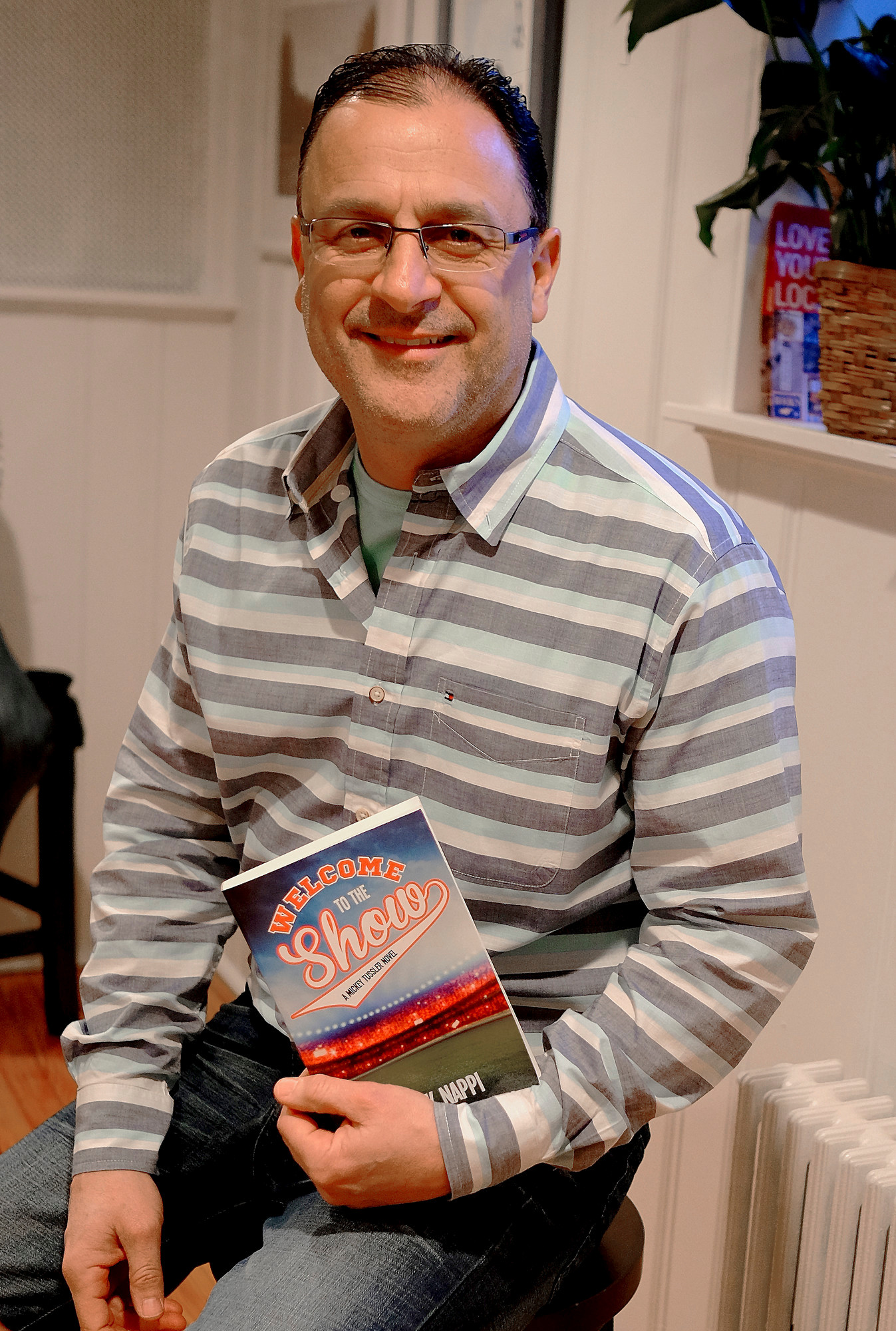 Frank Nappi with his third book in his Mickey Tussler series, “Welcome to the Show,” at Turn of the Corkscrew in April 2016.