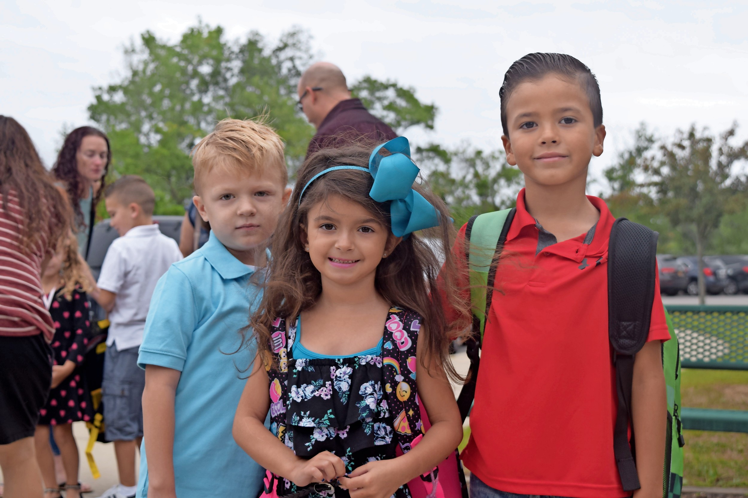 Lucas Meisenholder, 6, far left, Alessandra Saurman, 7, and Joe Vincent, 7, started a new school year at Seaford Harbor Elementary School this week. They are pictured on the first day of classes last year.