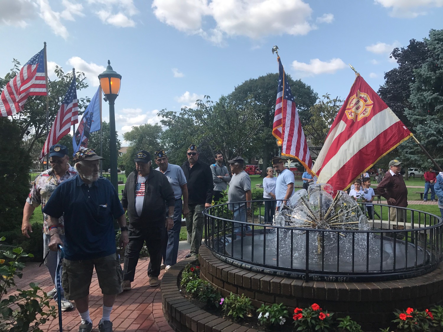 Five Towns military veterans led the Lawrence-Cedarhurst Fire Department around the 9/11 memorial fountain at Andrew J. Parise Cedarhurst Park.